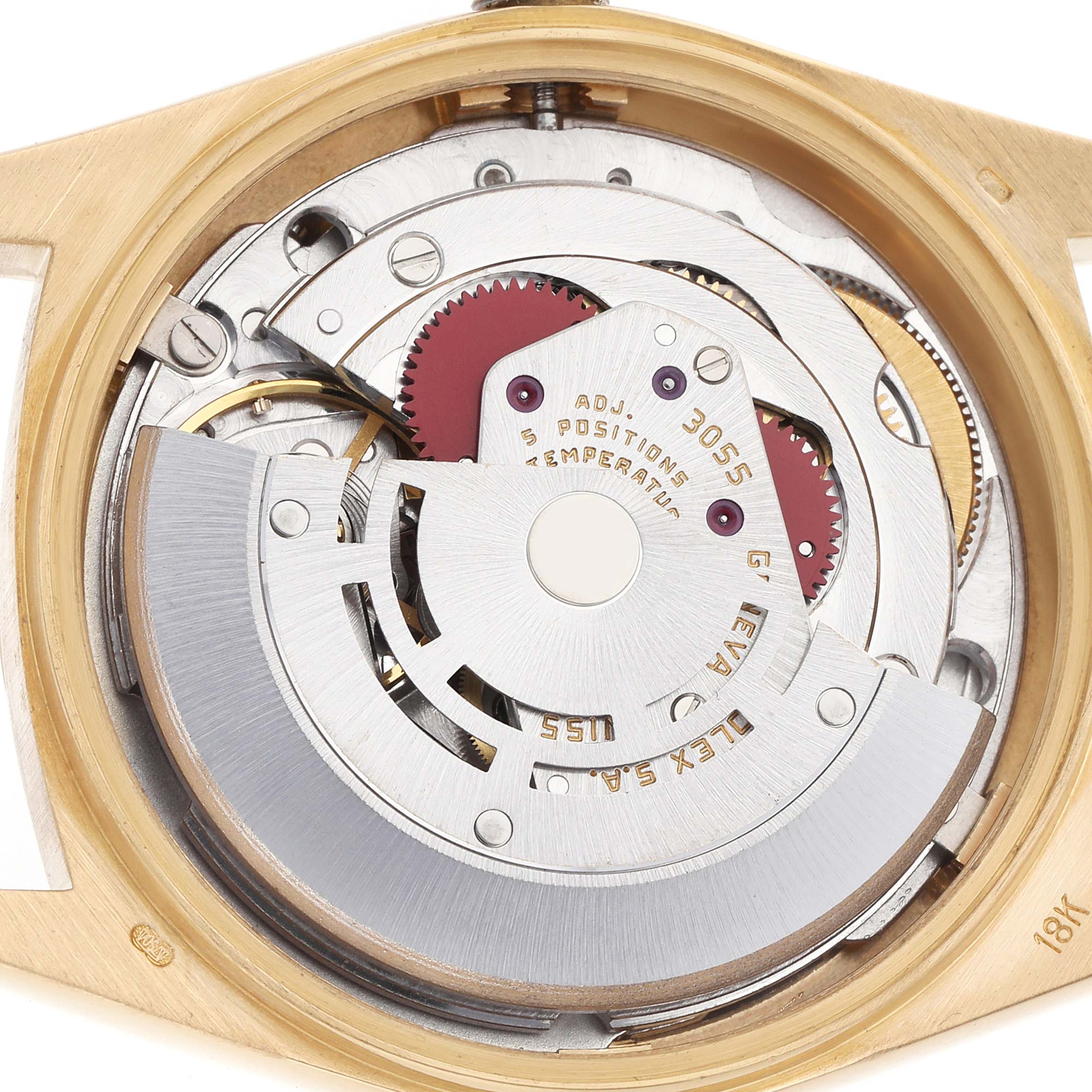 The image shows the movement of a Rolex President 18038 Men
s Yellow Gold Champagne Dial watch viewed from the back, highlighting gears and internal components.