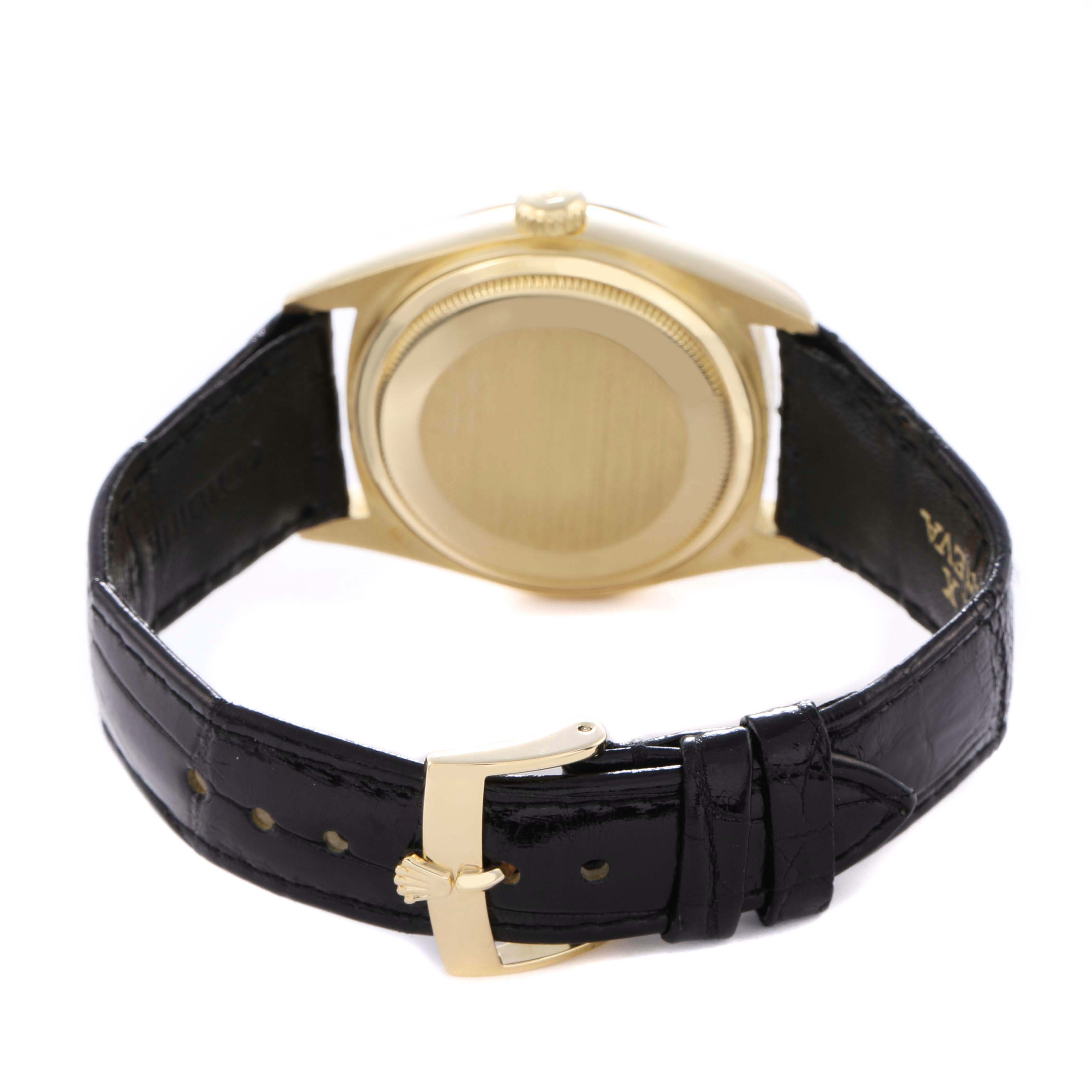 The image shows a Rolex President 18038 Men
s Yellow Gold Champagne Dial watch from the back, highlighting the case back and black leather strap with a gold buckle.