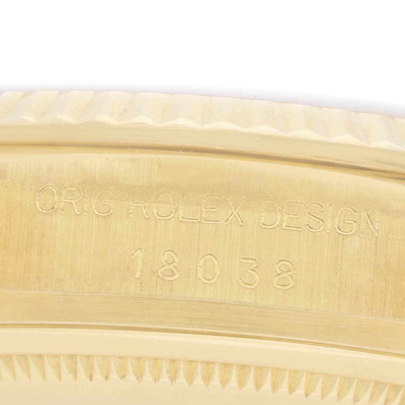 The image shows a close-up of the side of a Rolex President 18038 Men
s Yellow Gold Champagne Dial model, highlighting the model number engraving.