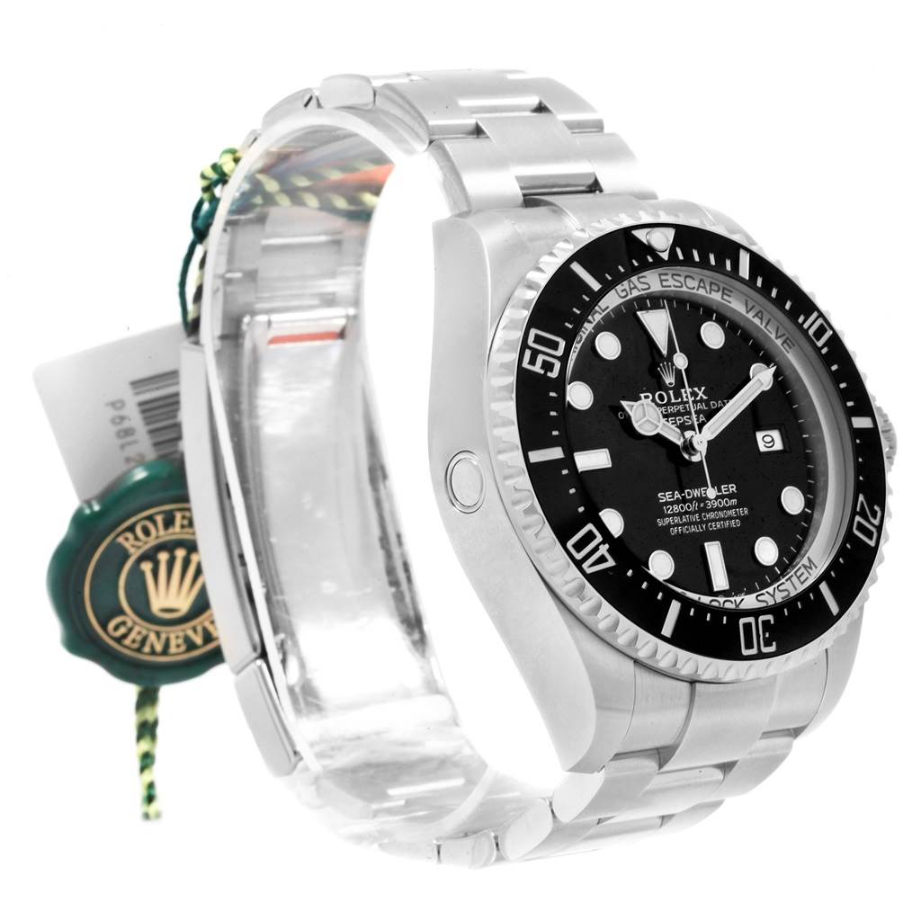 The image shows a left side view of a Rolex Sea-Dweller 126660 Men
s Stainless Steel Black Dial 126660 Men
s Stainless Steel Black Dial watch, highlighting its face, bezel, and bracelet with tags attached.