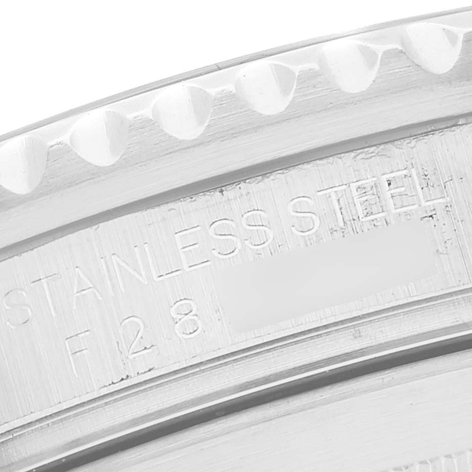 This close-up image shows the engraved words on the case back edge of the Rolex Submariner 16610 Men
s Stainless Steel Black Dial 16610 Men
s Stainless Steel Black Dial watch in stainless steel.