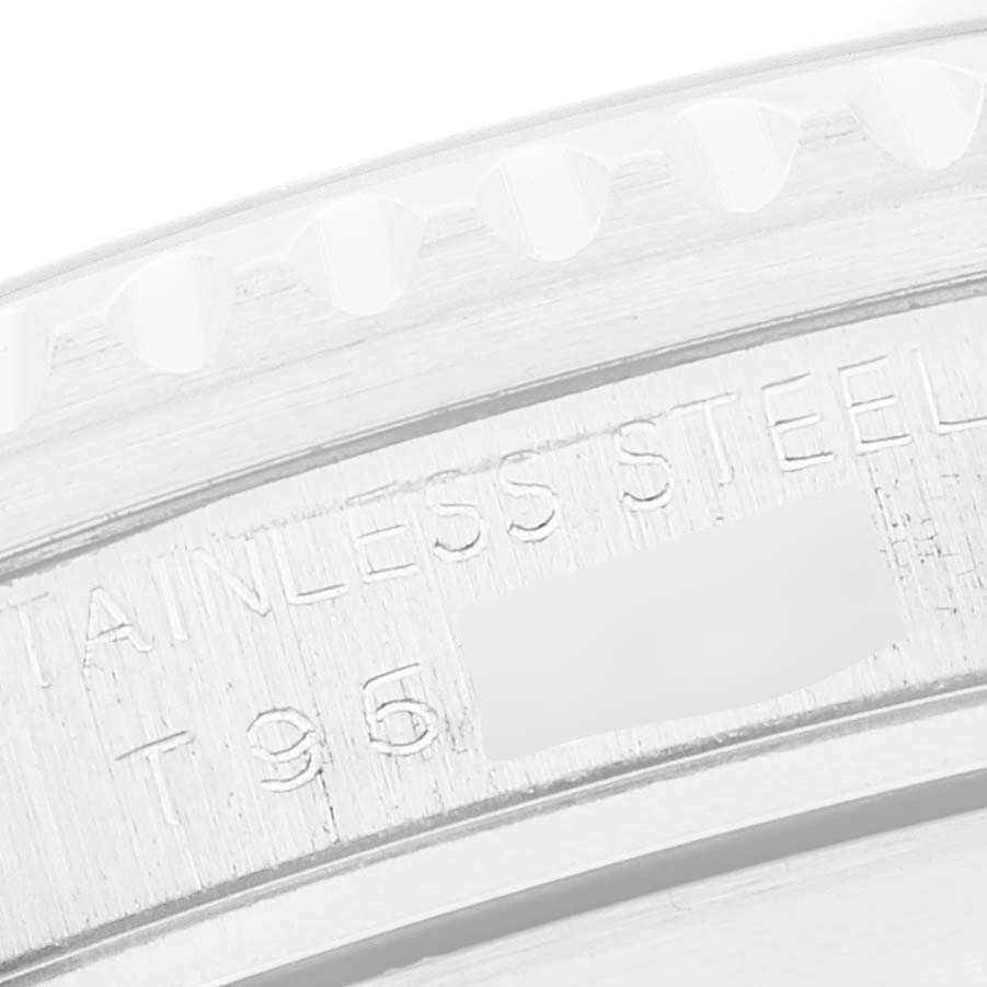 This is a close-up of the stainless steel case
s edge on a Rolex Submariner 16610 Men
s Stainless Steel Black Dial 16610 Men
s Stainless Steel Black Dial watch, showing part of the engraved text.