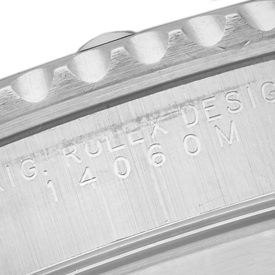 This image shows a close-up of the case side of a Rolex Submariner 14060M Men
s Stainless Steel Black Dial 14060M Men
s Stainless Steel Black Dial, focusing on the serial number engraving and part of the bezel.