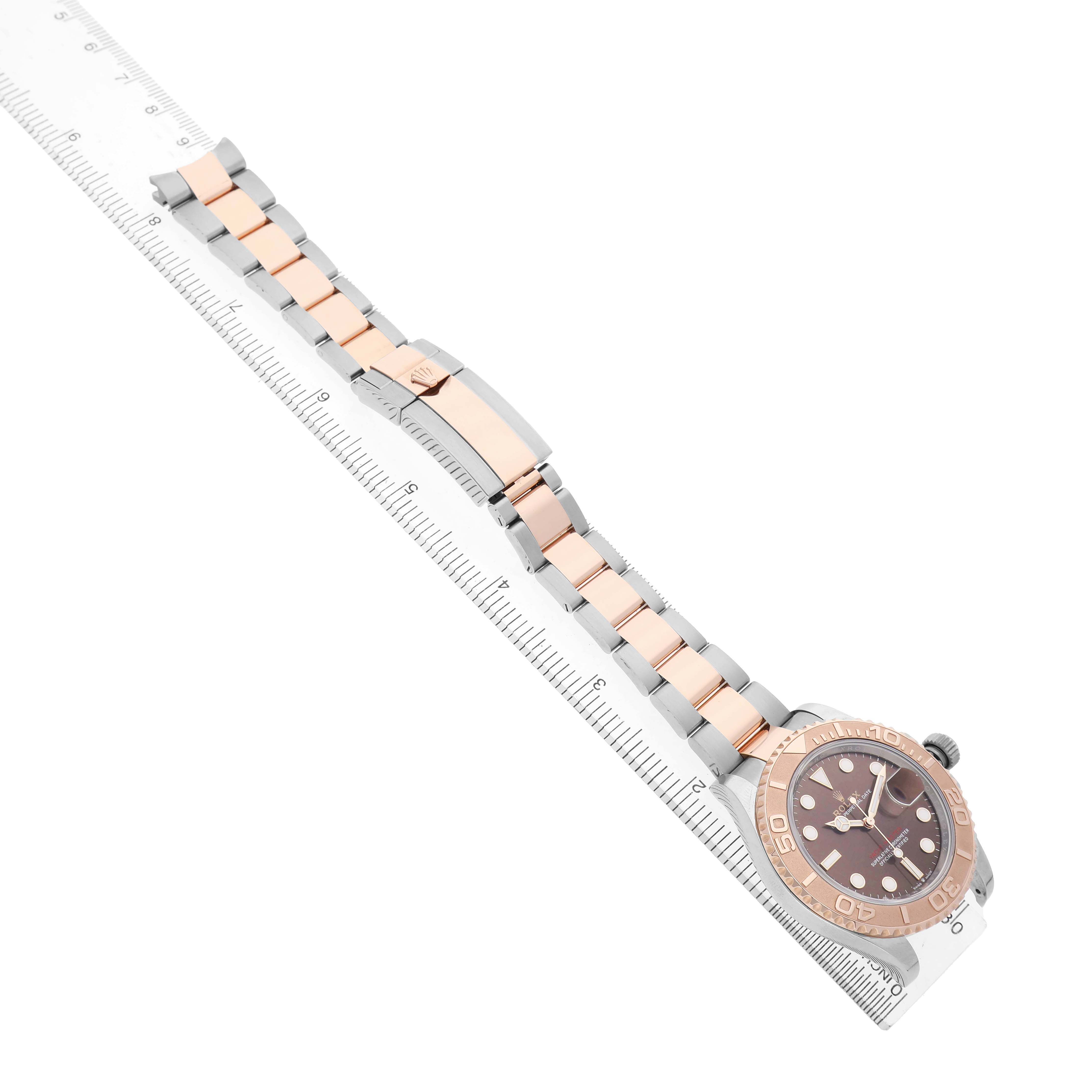 The Rolex Yacht-Master 126621 Men's Stainless Steel Brown Dial watch is shown from a top view, highlighting the entire bracelet, clasp, and face.