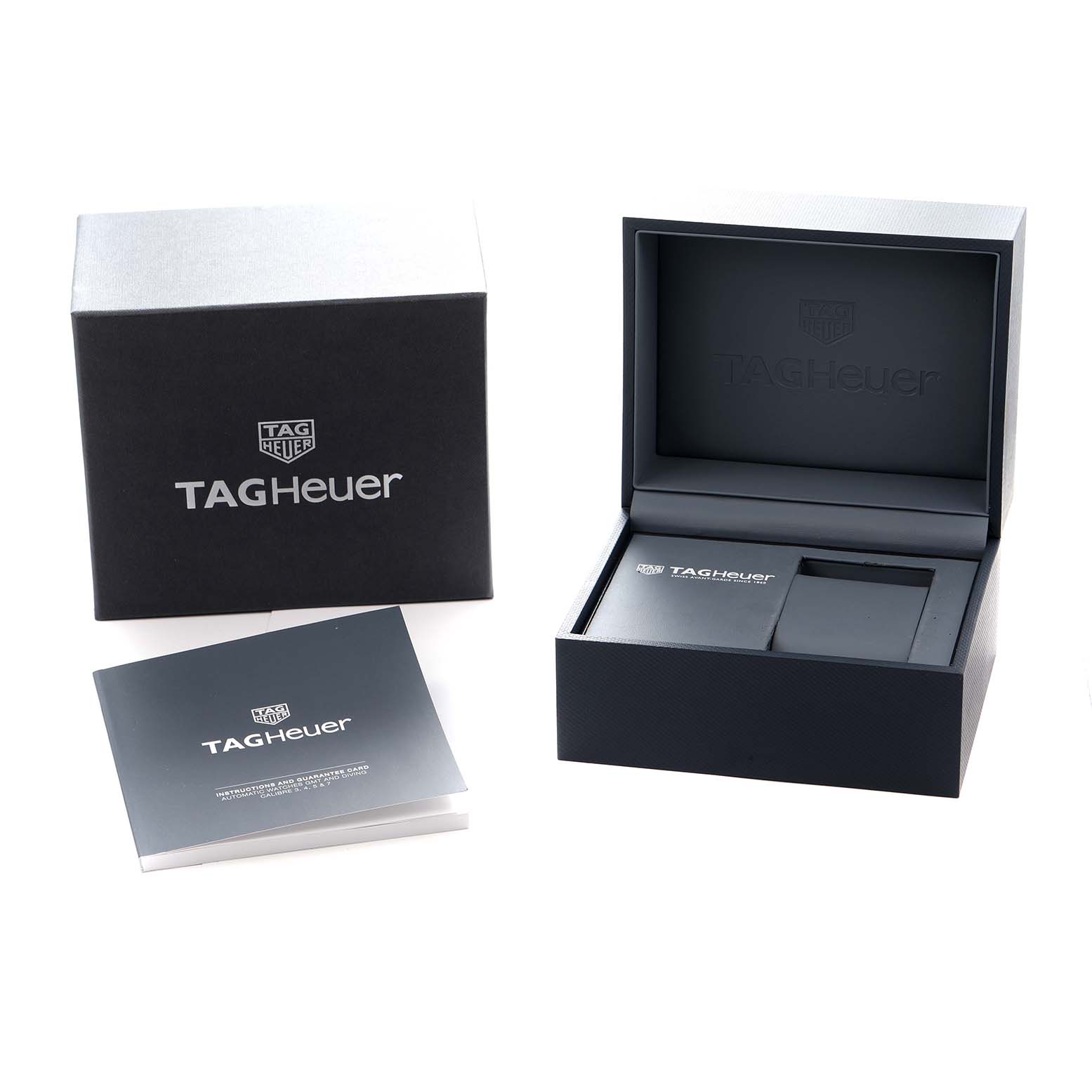 The image shows a Tag Heuer Autavia WBE5114 Men
s Stainless Steel Brown Dial watch box and manual from a front angle.