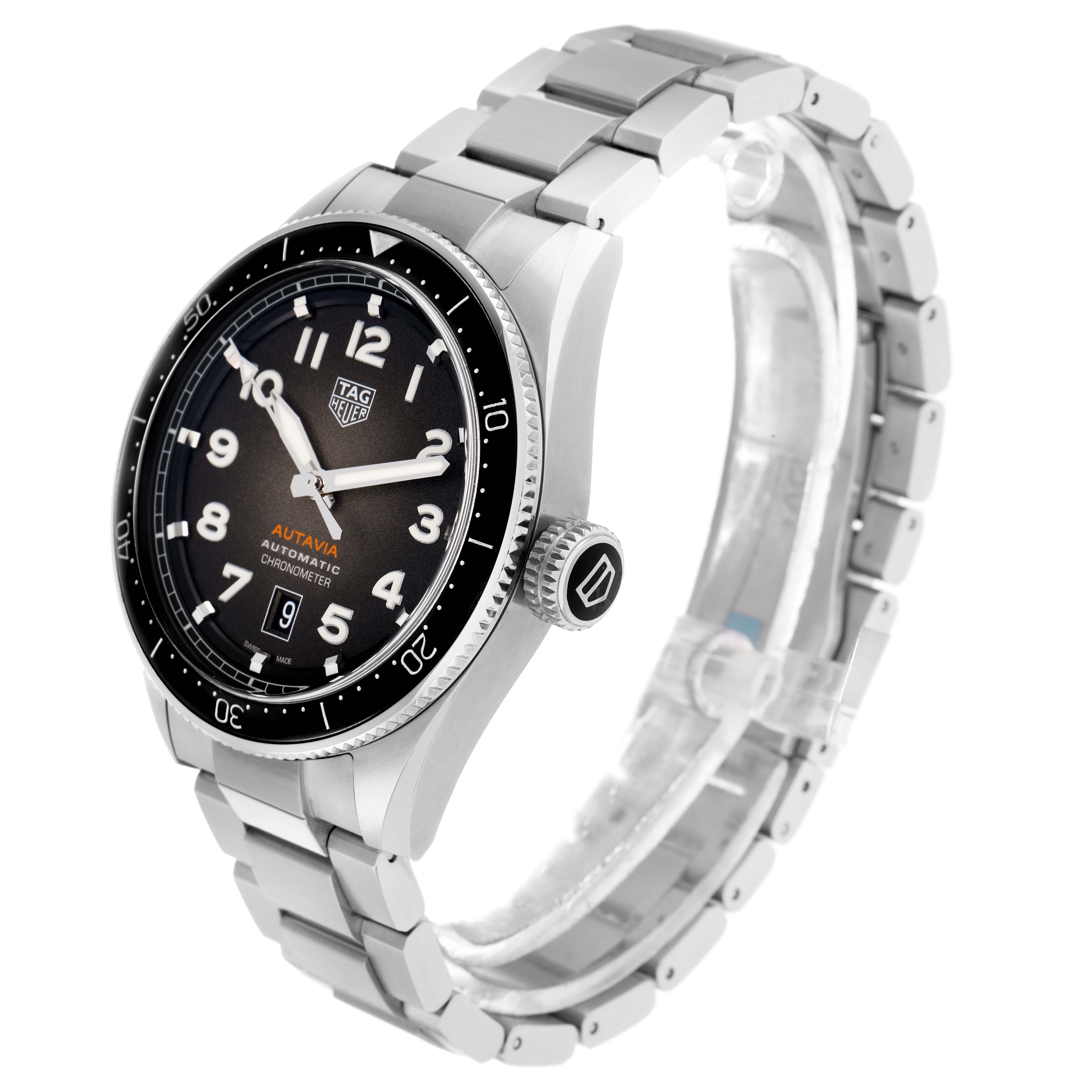 The Tag Heuer Autavia WBE5114 Men
s Stainless Steel Brown Dial watch is shown at a three-quarter angle, displaying the dial, bezel, case, crown, and metal bracelet.