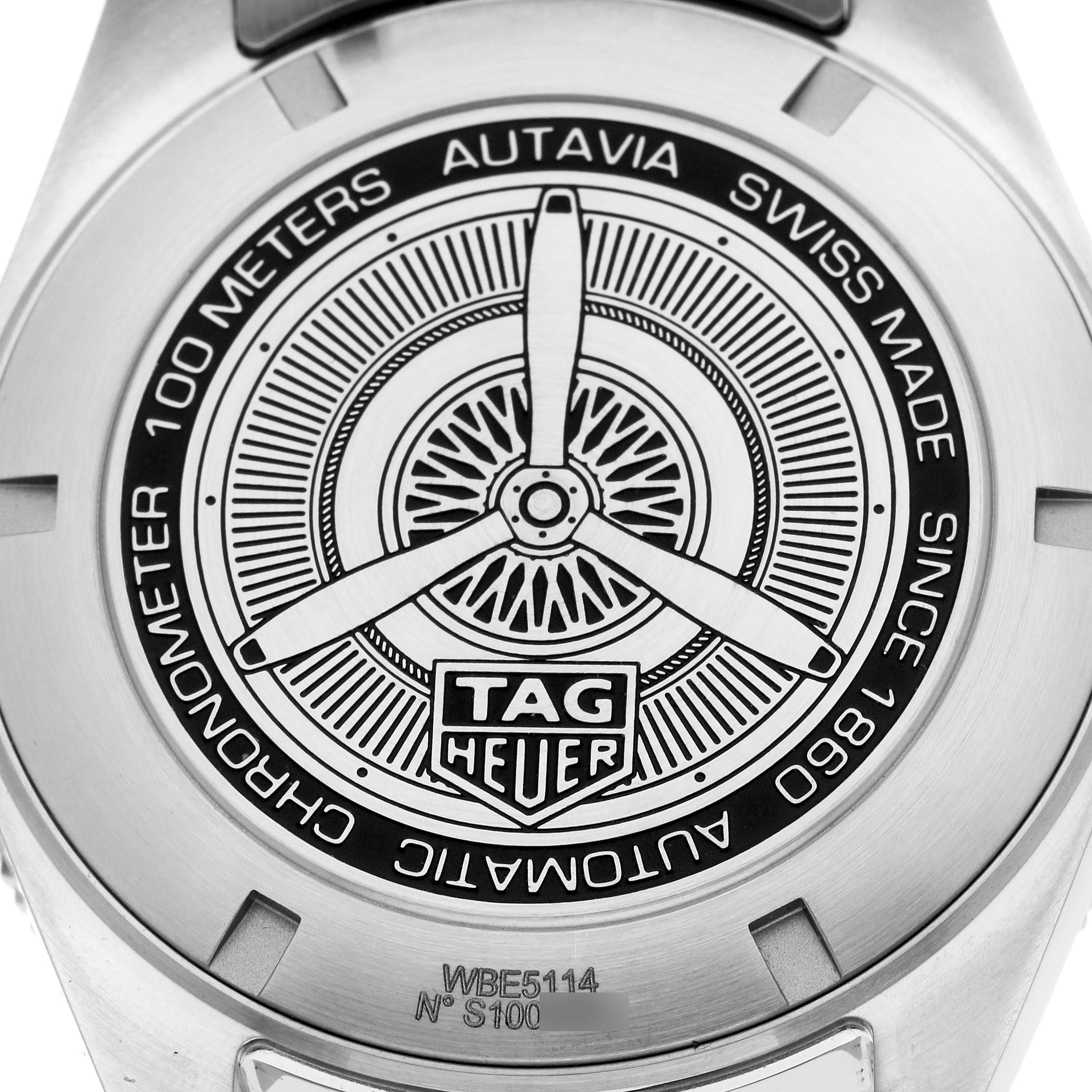 The image shows the case back of a Tag Heuer Autavia WBE5114 Men
s Stainless Steel Brown Dial watch, featuring its engraved design and branding.