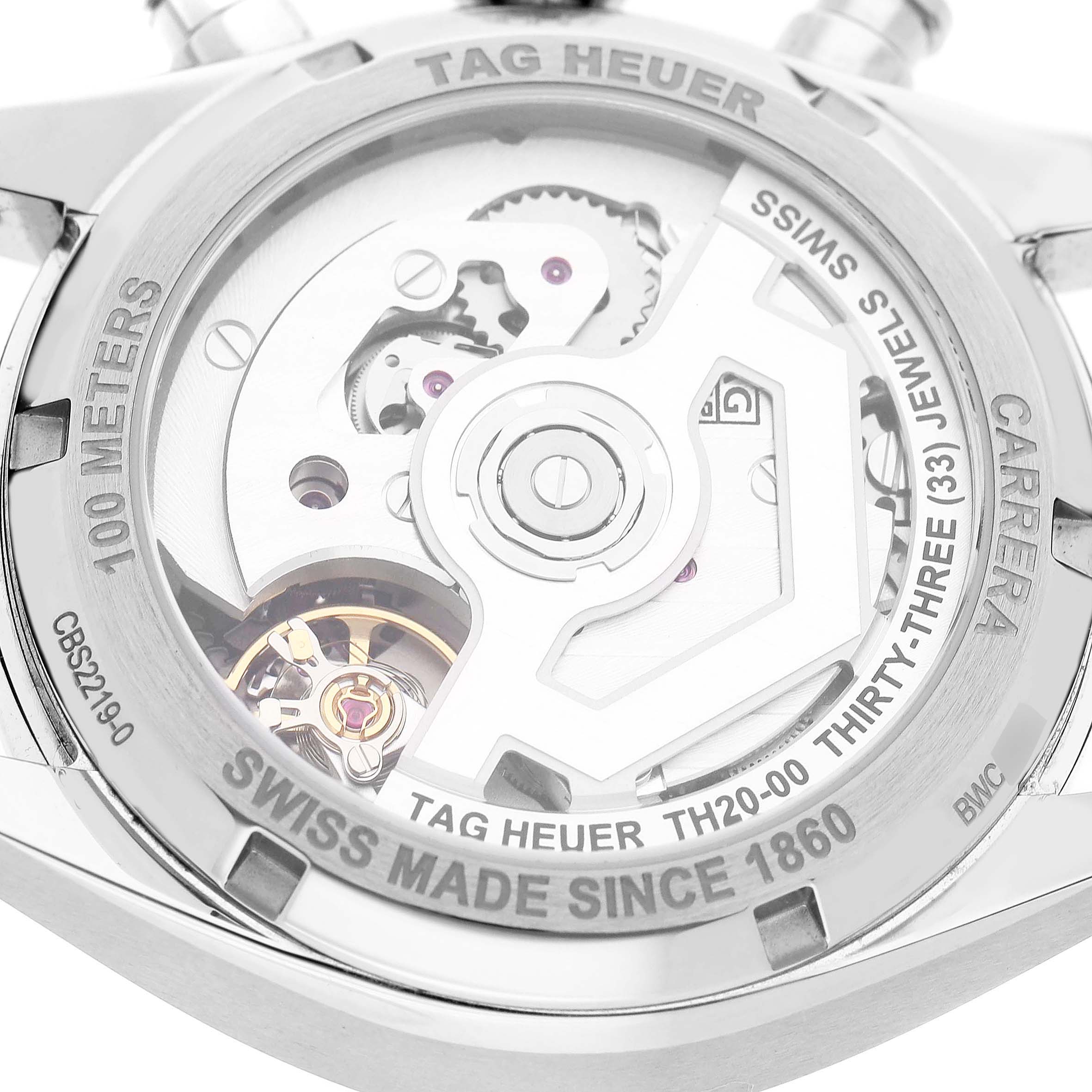 The image shows the back of a Tag Heuer Carrera CBS2219.FC6607 Men's Stainless Steel Purple Dial watch, highlighting its movement and internal mechanics.