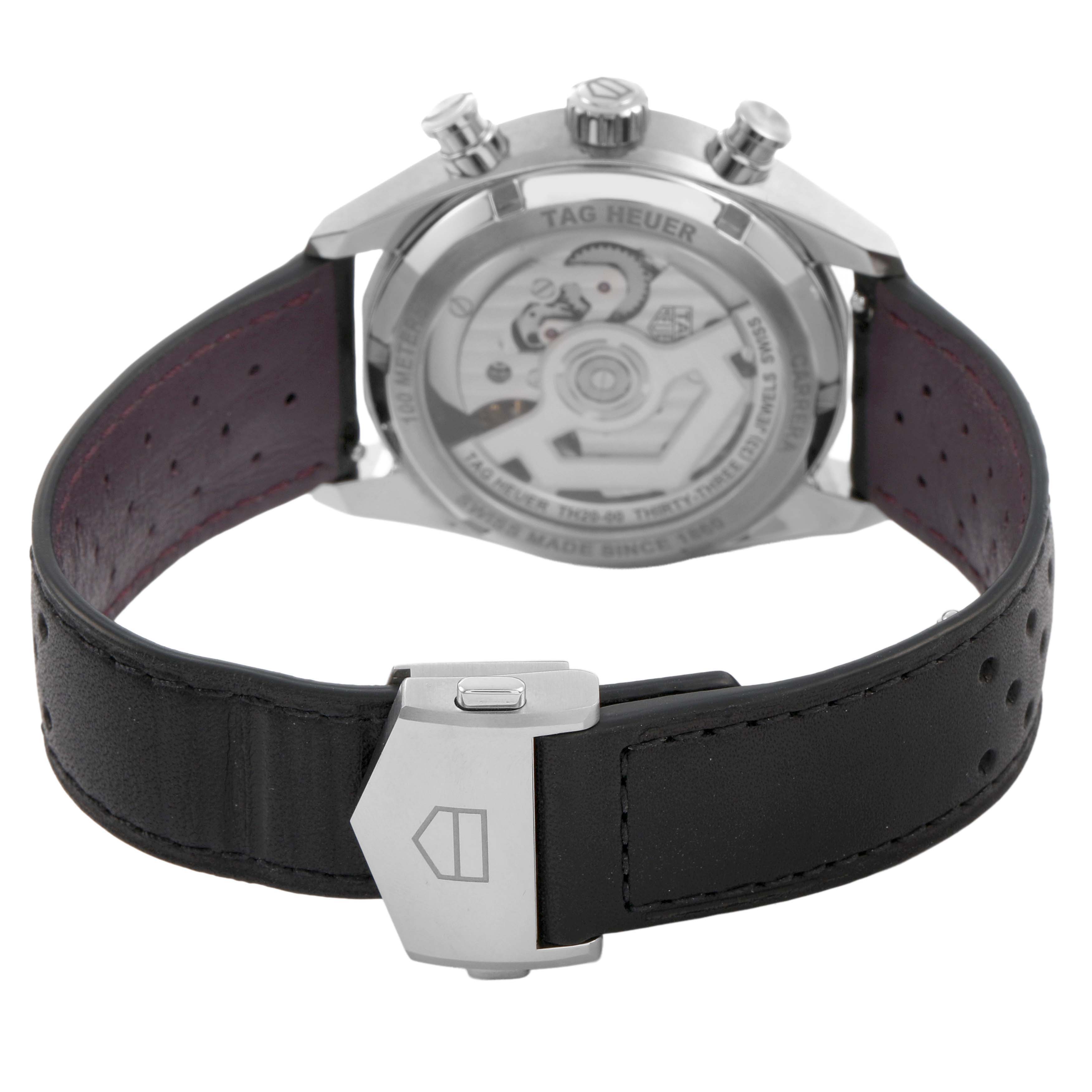 The Tag Heuer Carrera CBS2219.FC6607 Men's Stainless Steel Purple Dial watch is shown from the back, displaying the transparent case back and a leather strap with a clasp.