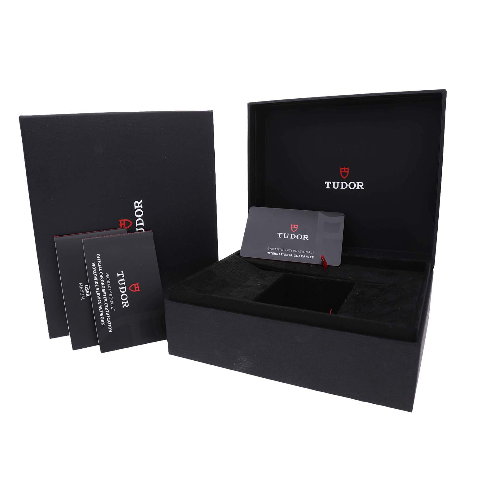 The image shows an open Tudor Heritage Black Bay M7939G1A0NRU Men's Stainless Steel Black Dial watch box with brand documents and a warranty card displayed.