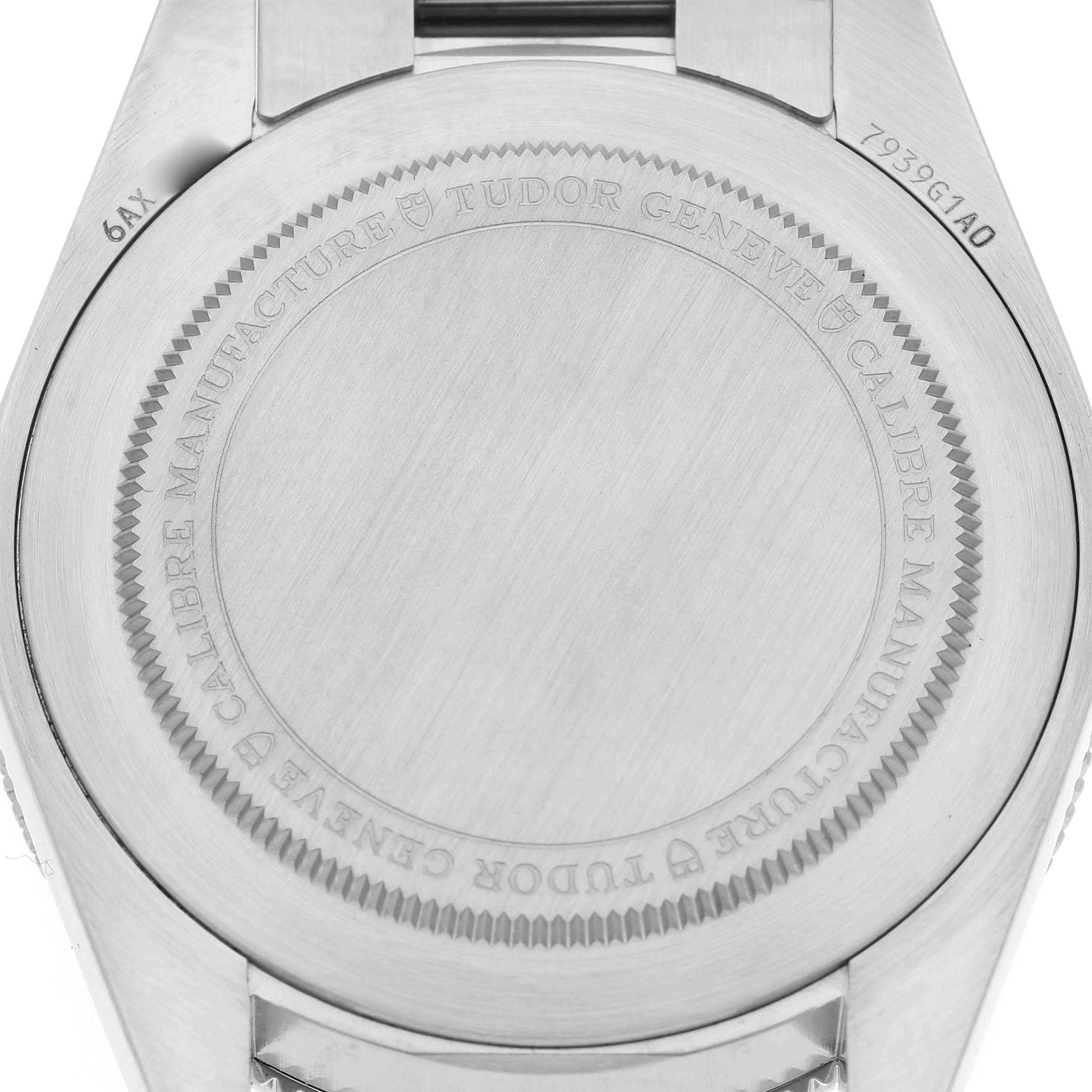 The image shows the case back of a Tudor Heritage Black Bay M7939G1A0NRU Men's Stainless Steel Black Dial watch, highlighting its engraved details.