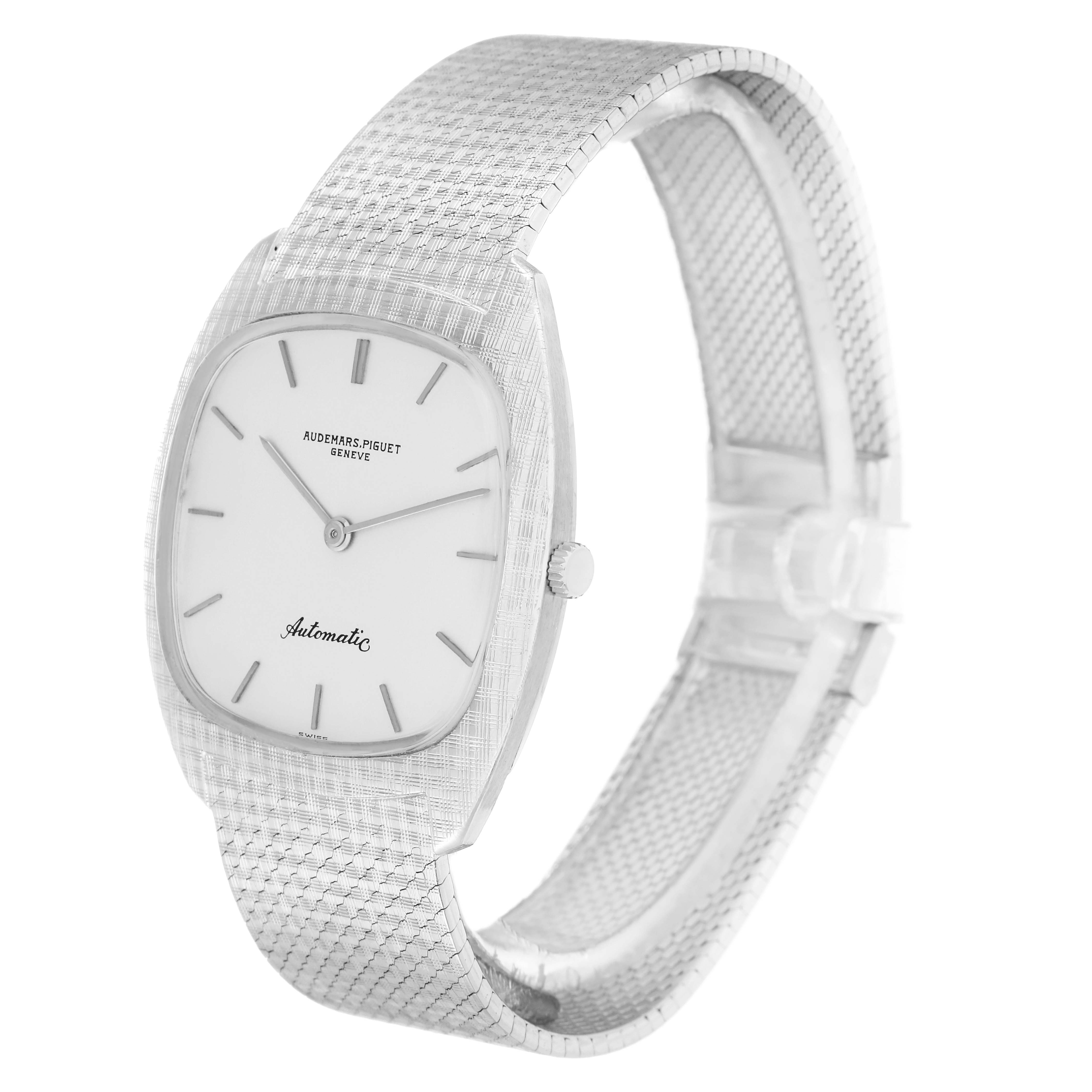 The Vintage Audemars Piguet watch is shown at a three-quarter angle, featuring the dial, crown, and textured strap.