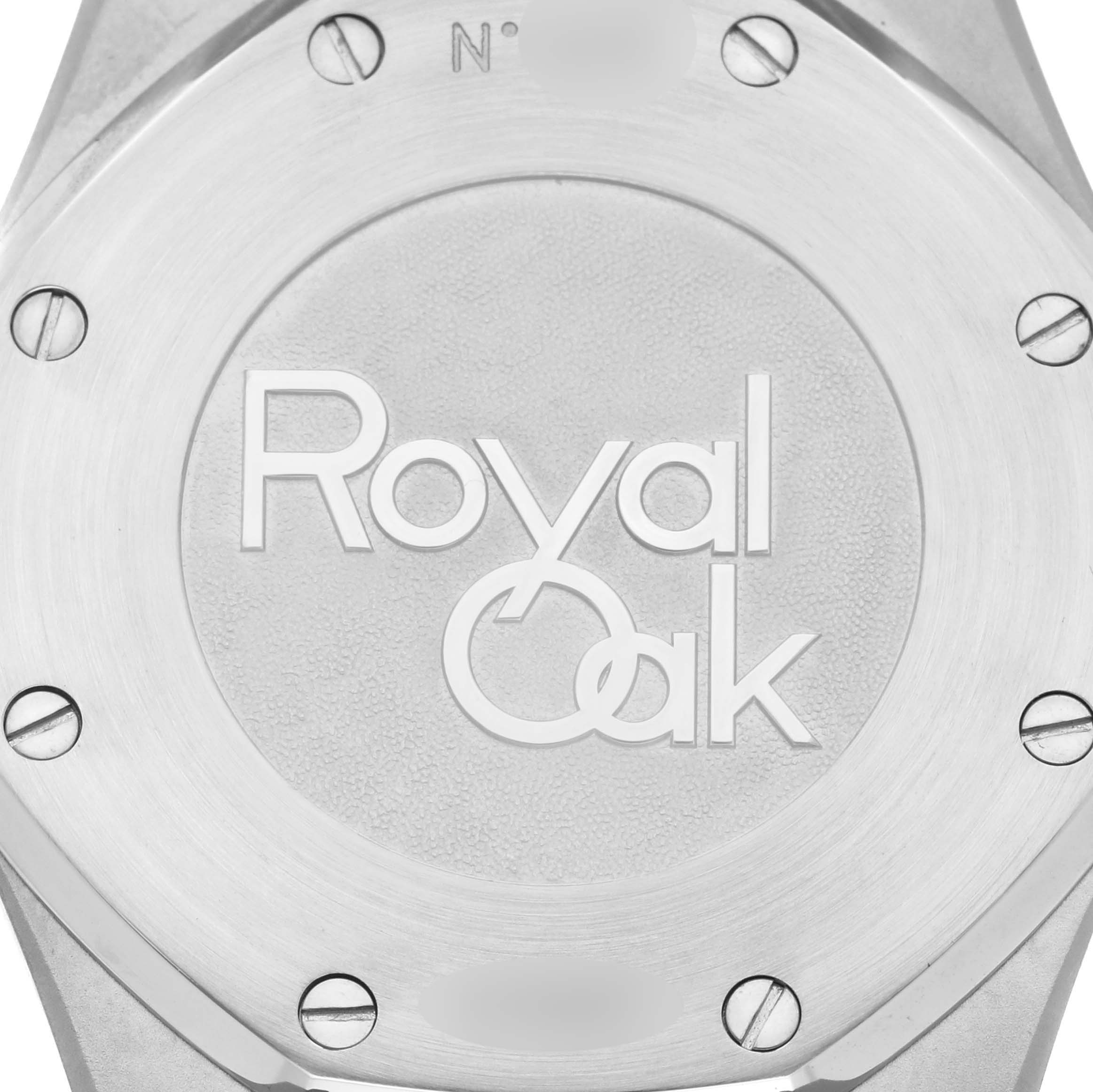 The image shows the stainless steel case back of an Audemars Piguet Royal Oak 26120ST.OO.1220ST.03 Men's Stainless Steel Black Dial 26120ST.OO.1220ST.03 Men's Stainless Steel Black Dial watch, featuring engraved logo and screws.