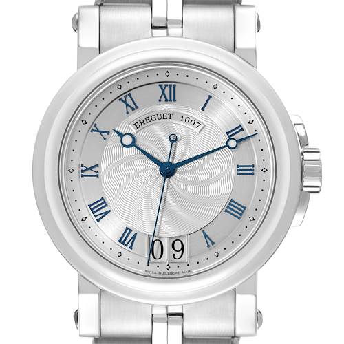 The Breguet Marine model watch is shown from the front, displaying its dial, hands, Roman numerals, and part of the bracelet.