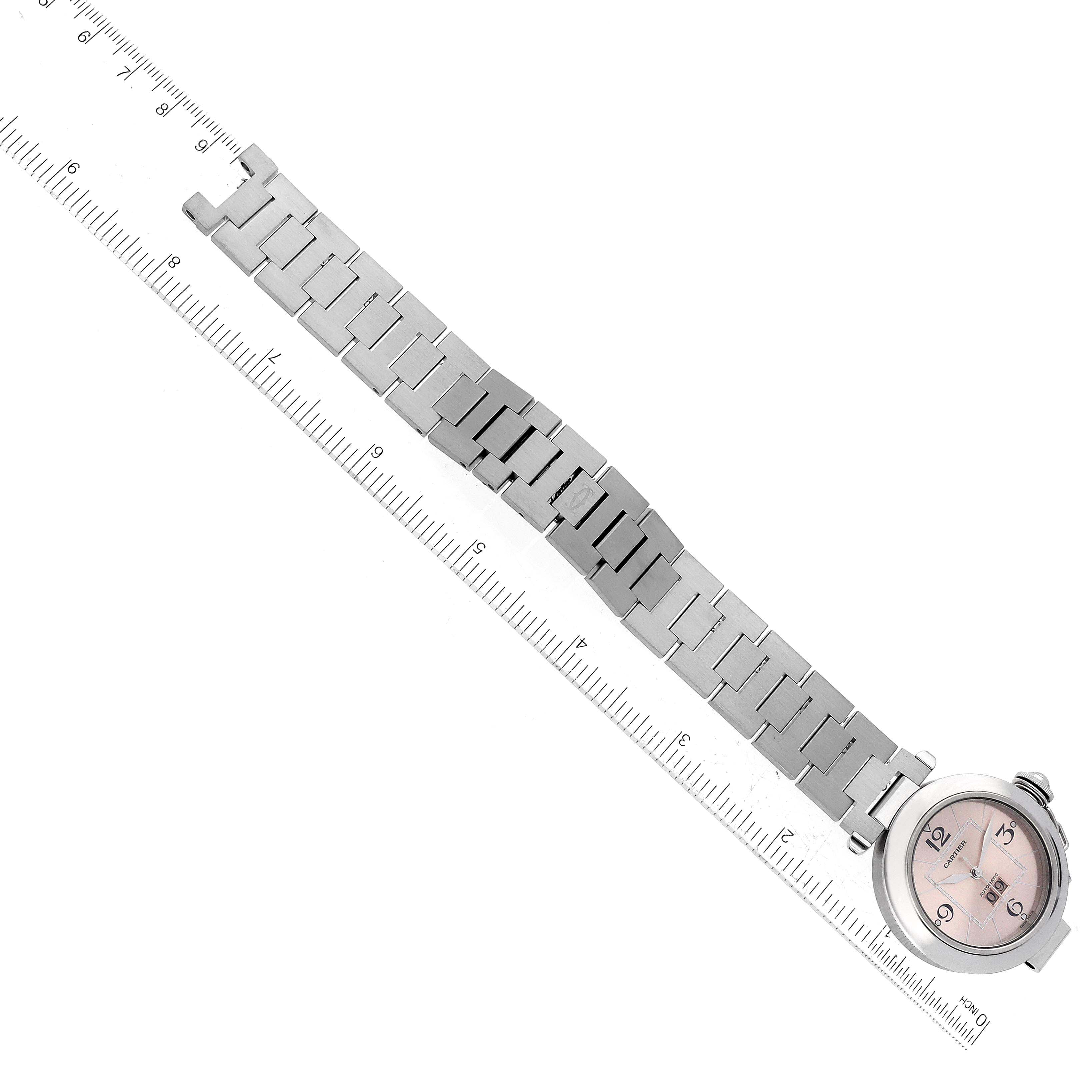 The image shows a top-down view of a Cartier Pasha W31058M7 Women's Stainless Steel Pink Dial W31058M7 Women's Stainless Steel Pink Dial watch, displaying the watch face, bracelet, and a ruler for scale.