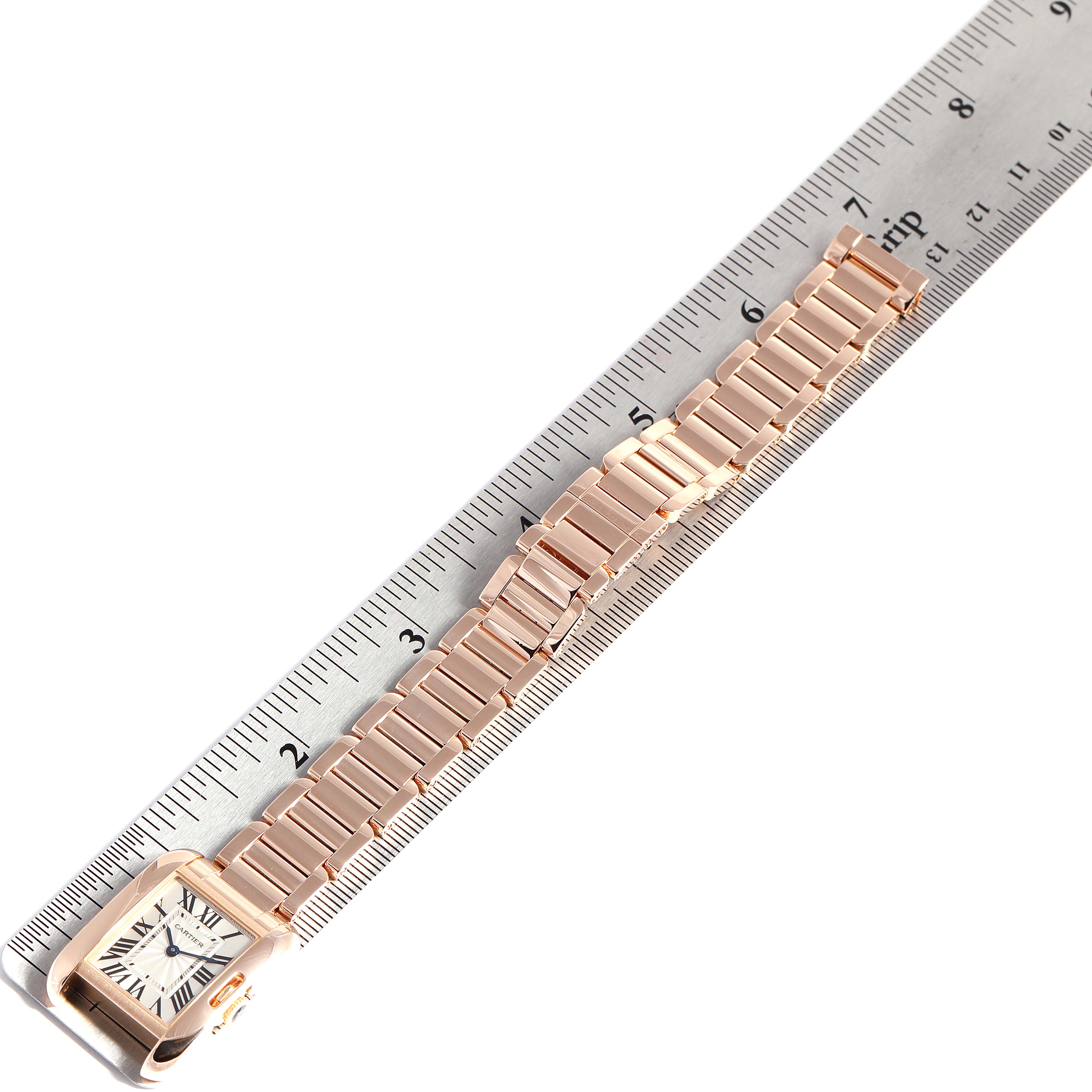 The Cartier Tank Anglaise W5310013 Women's Rose Gold Silver Dial W5310013 Women's Rose Gold Silver Dial watch is shown from a top-down angle, displayed alongside a ruler for measurement.