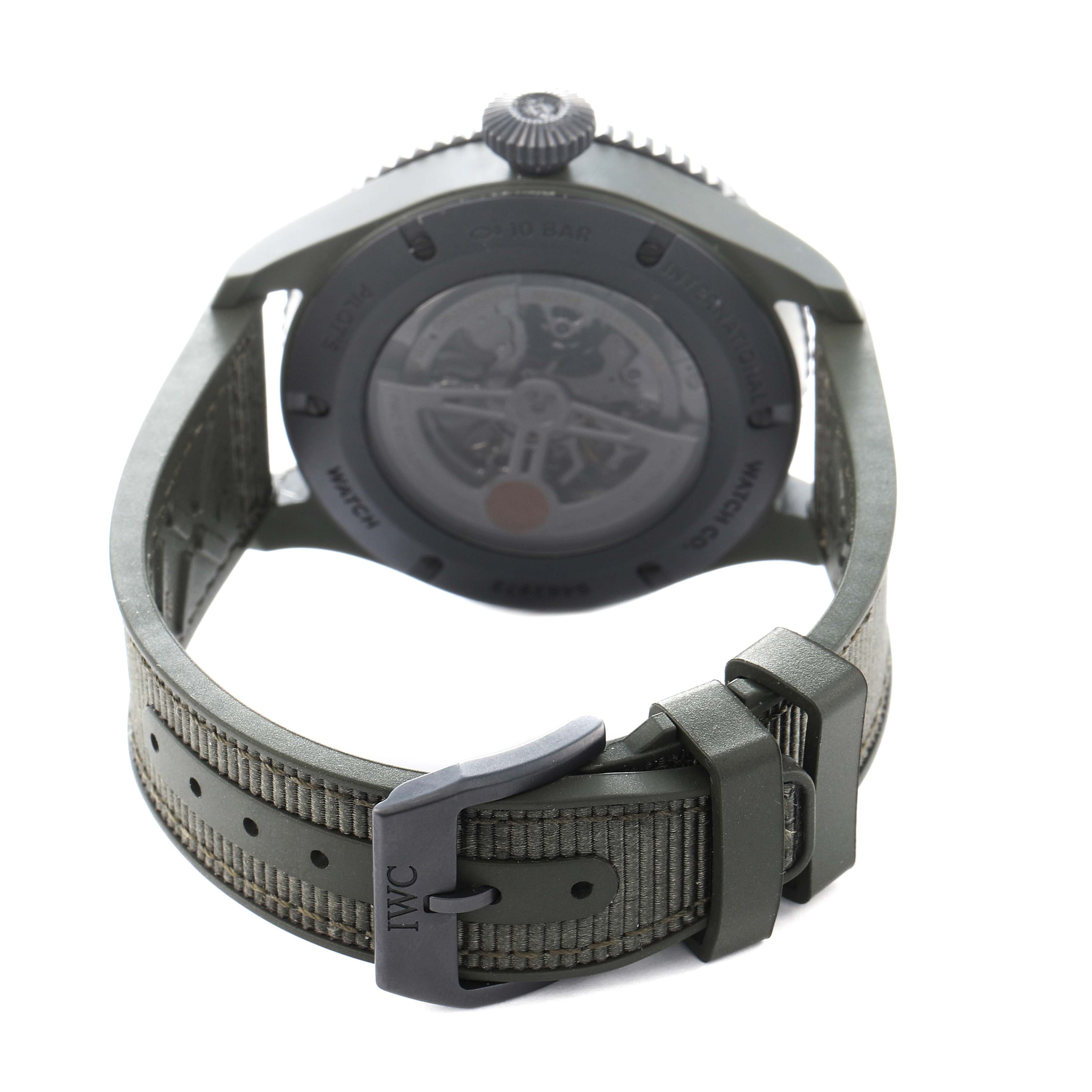 The image shows the back of the IWC Pilot IW395601 Men
s Ceramic Green Dial watch, highlighting the transparent case back and strap with a buckle.