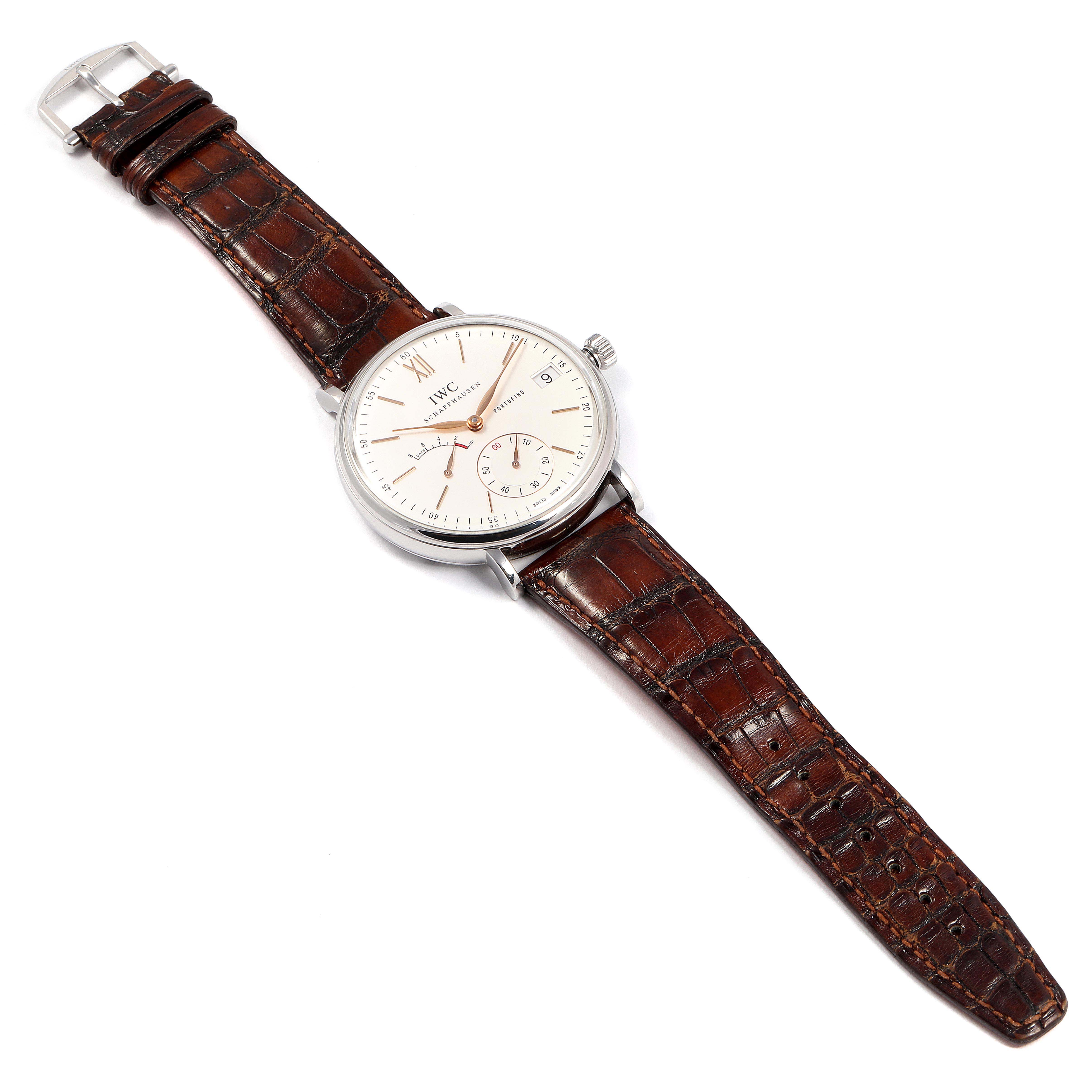 The image shows the IWC Portofino IW510103 Men's Stainless Steel Silver Dial IW510103 Men's Stainless Steel Silver Dial watch from a top-down angle, highlighting its brown leather strap and silver watch face.