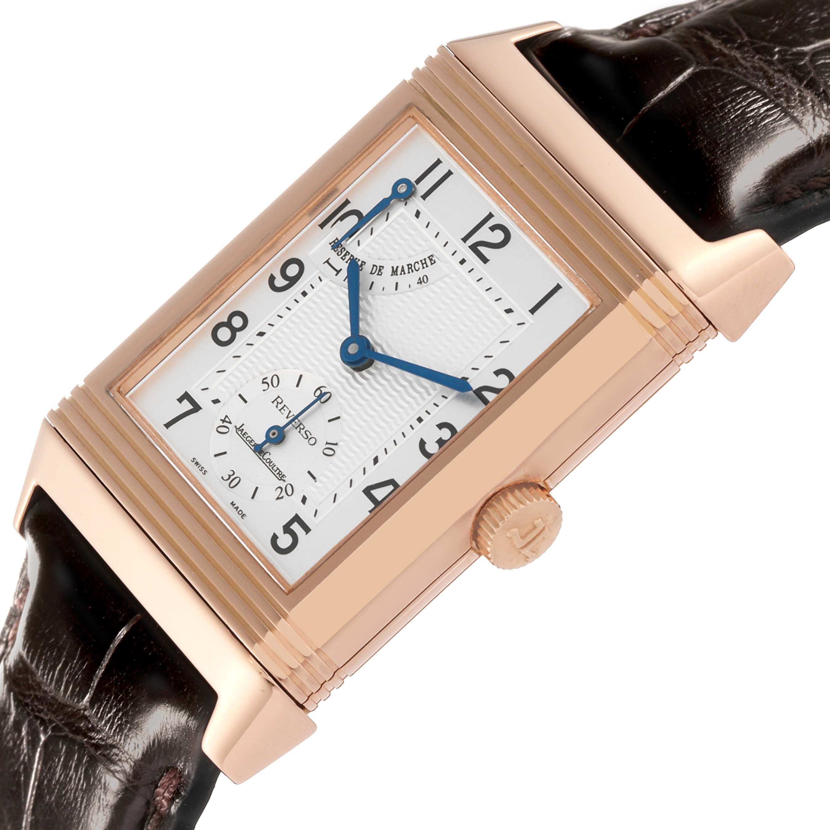 This image shows a close-up of the Jaeger LeCoultre Reverso Q2702420 Men's Rose Gold Silver Dial Q2702420 Men's Rose Gold Silver Dial watch face, crown, and leather strap from an angled view.