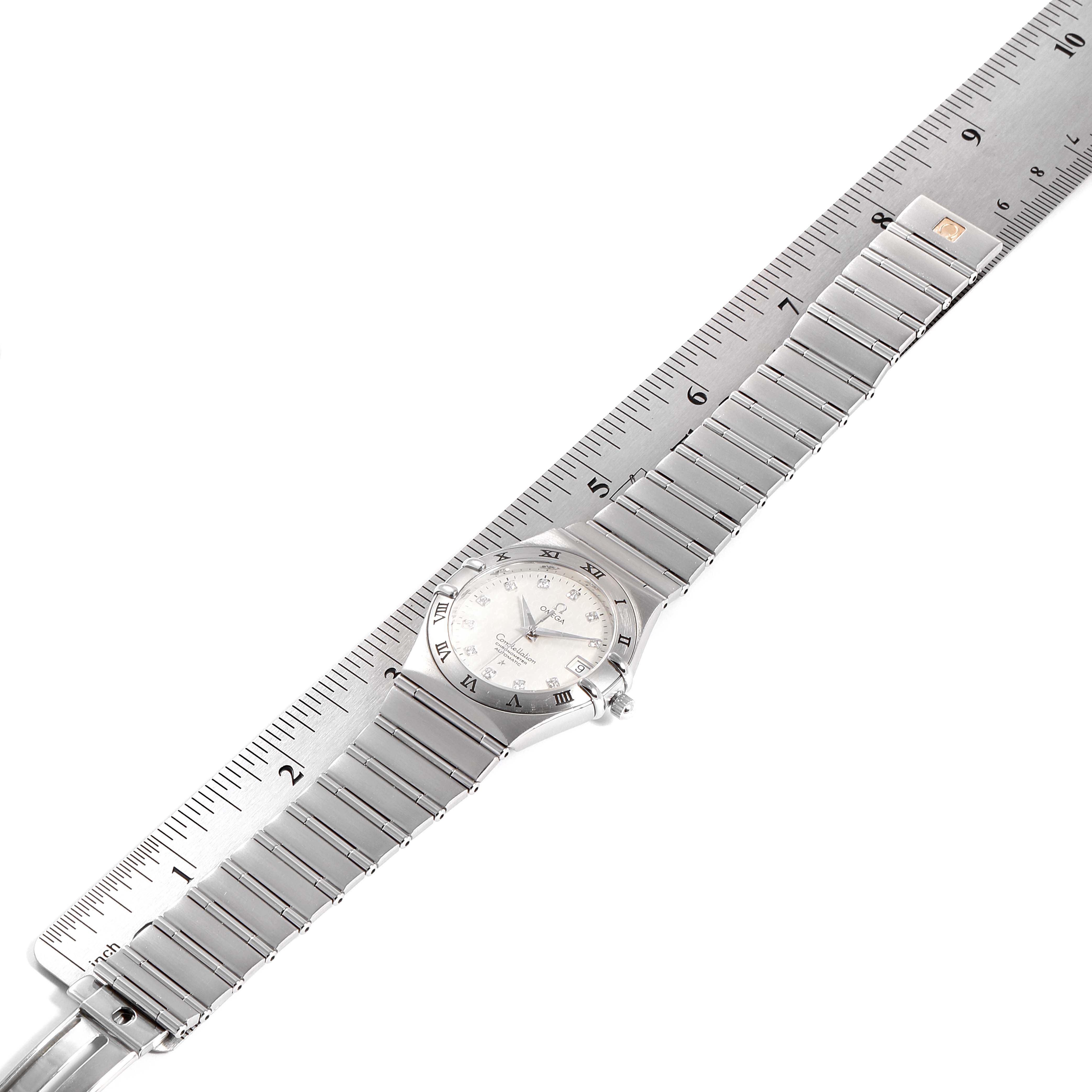 The image shows an Omega Constellation 1504.35.00 Men's Stainless Steel Silver Dial 1504.35.00 Men's Stainless Steel Silver Dial watch laid flat alongside a ruler, displaying its face, case, and bracelet.