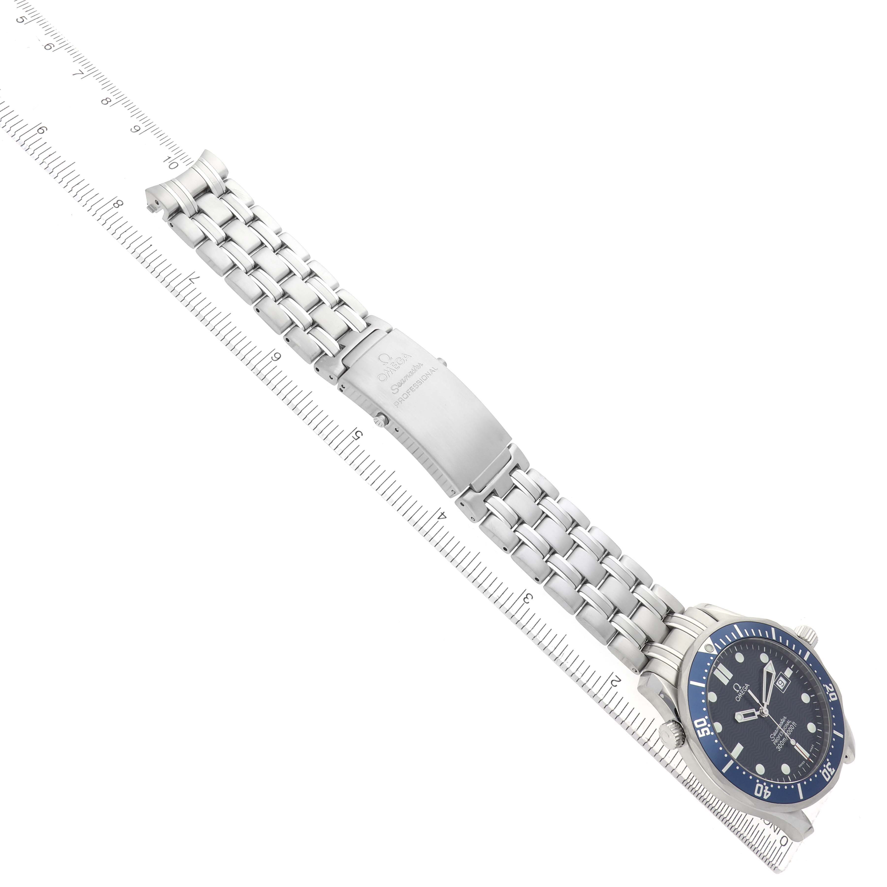 The Omega Seamaster 2541.80.00 Men
s Stainless Steel Blue Dial watch is shown at a slight angle, displaying the face, bezel, and metal bracelet alongside a measuring ruler.