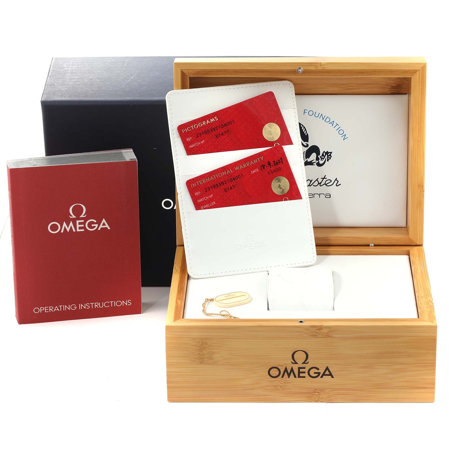 The image shows the packaging and accessories for the Omega Aqua Terra 231.90.39.21.04.001 Men's Stainless Steel White Dial 231.90.39.21.04.001 Men's Stainless Steel White Dial, including the operating instructions, warranty cards, and a wooden box.