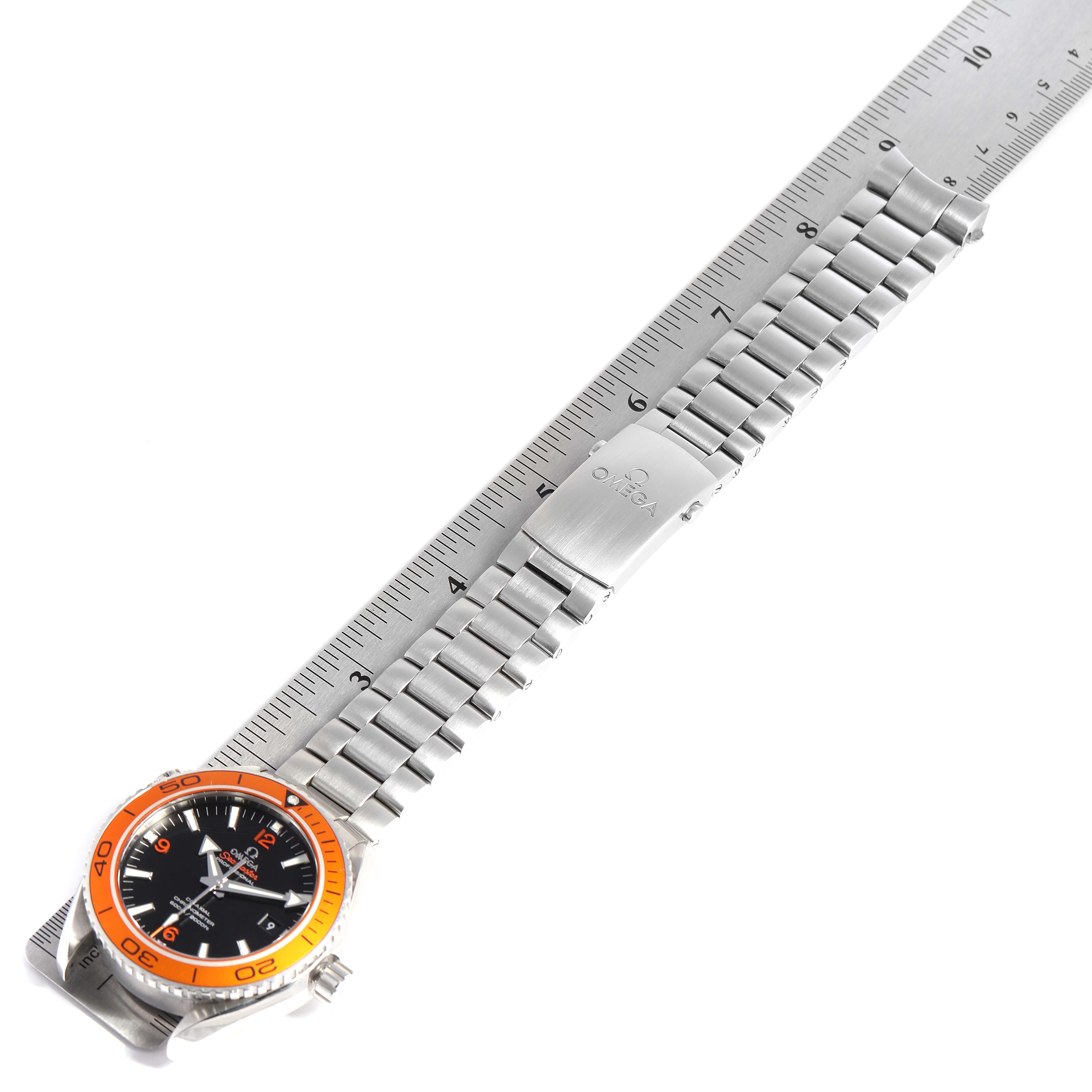 The image shows the entire Omega Planet Ocean 232.30.46.21.01.002 Men's Stainless Steel Black Dial 232.30.46.21.01.002 Men's Stainless Steel Black Dial watch, lying flat with its stainless steel bracelet extended and measured against a ruler.