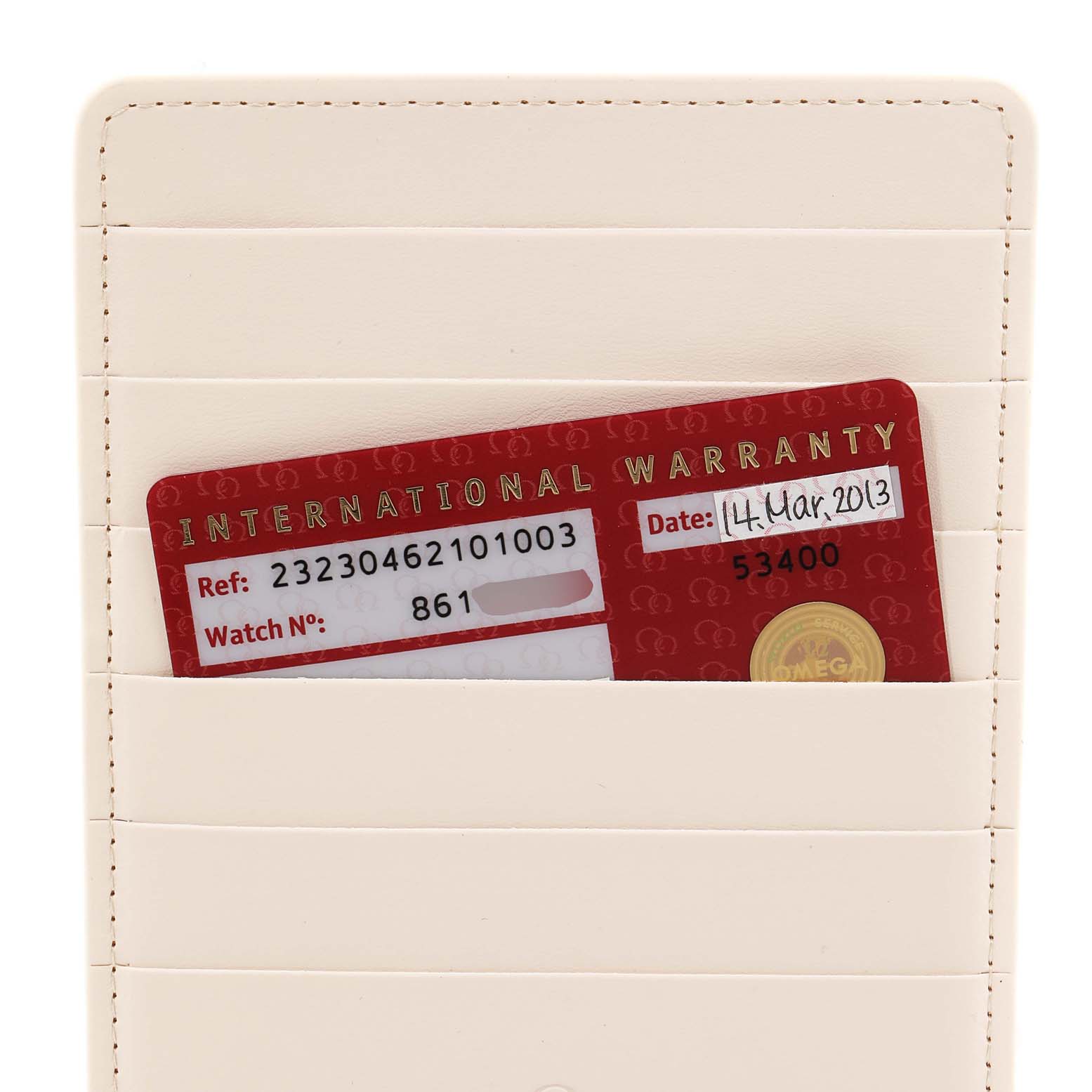 The image shows the international warranty card for the Omega Seamaster 232.30.46.21.01.003 Men's Stainless Steel Black Dial 232.30.46.21.01.003 Men's Stainless Steel Black Dial watch, partially out of a cream cardholder.