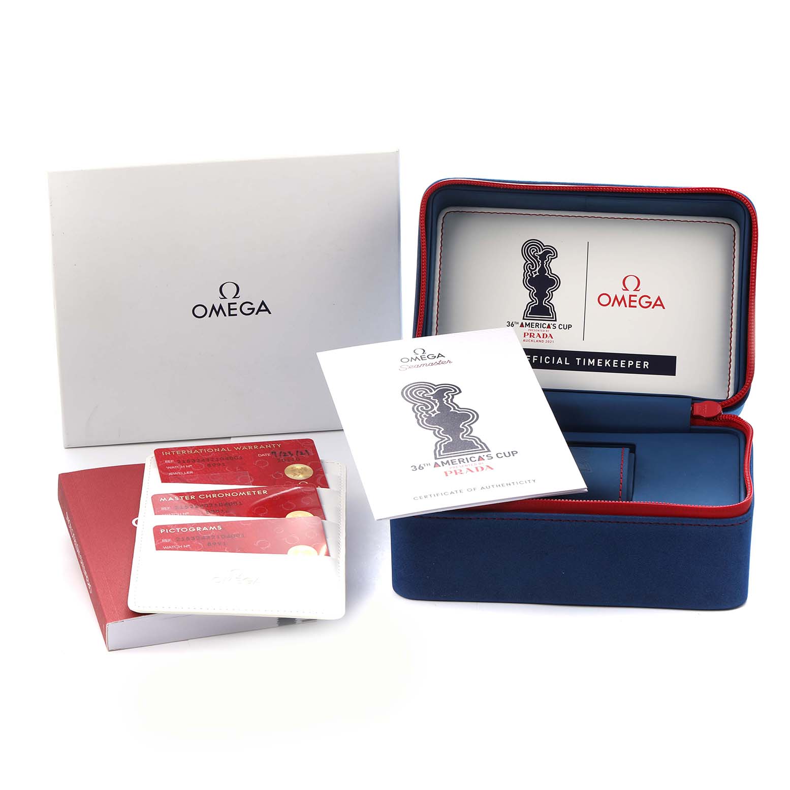 The image shows the packaging and accessories for the Omega Planet Ocean 215.32.43.21.04.001 Men
s Stainless Steel White Dial, including cards, booklets, and a watch case.