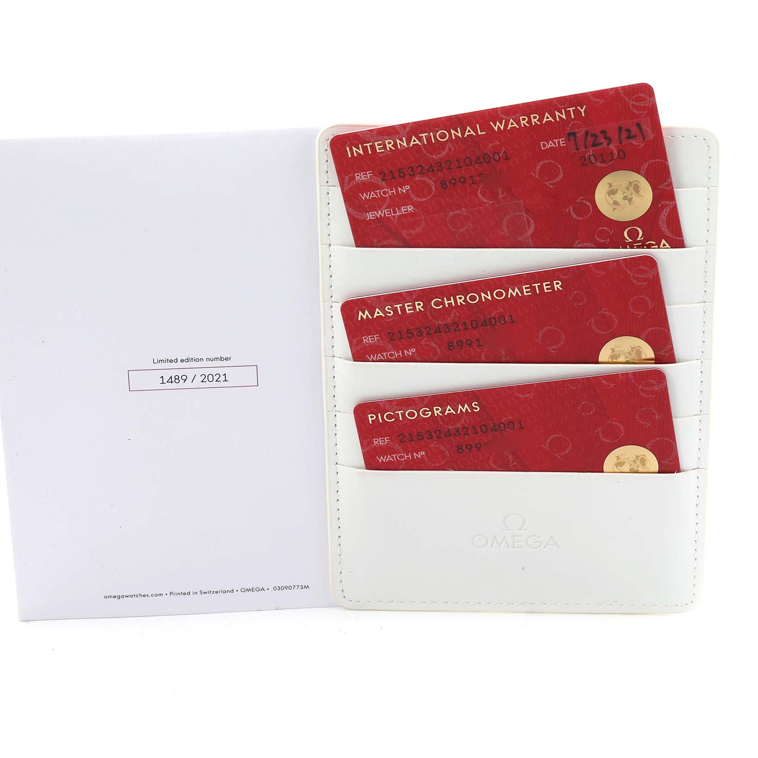 The image shows a close-up of warranty and certification cards for the Omega Planet Ocean 215.32.43.21.04.001 Men
s Stainless Steel White Dial model.