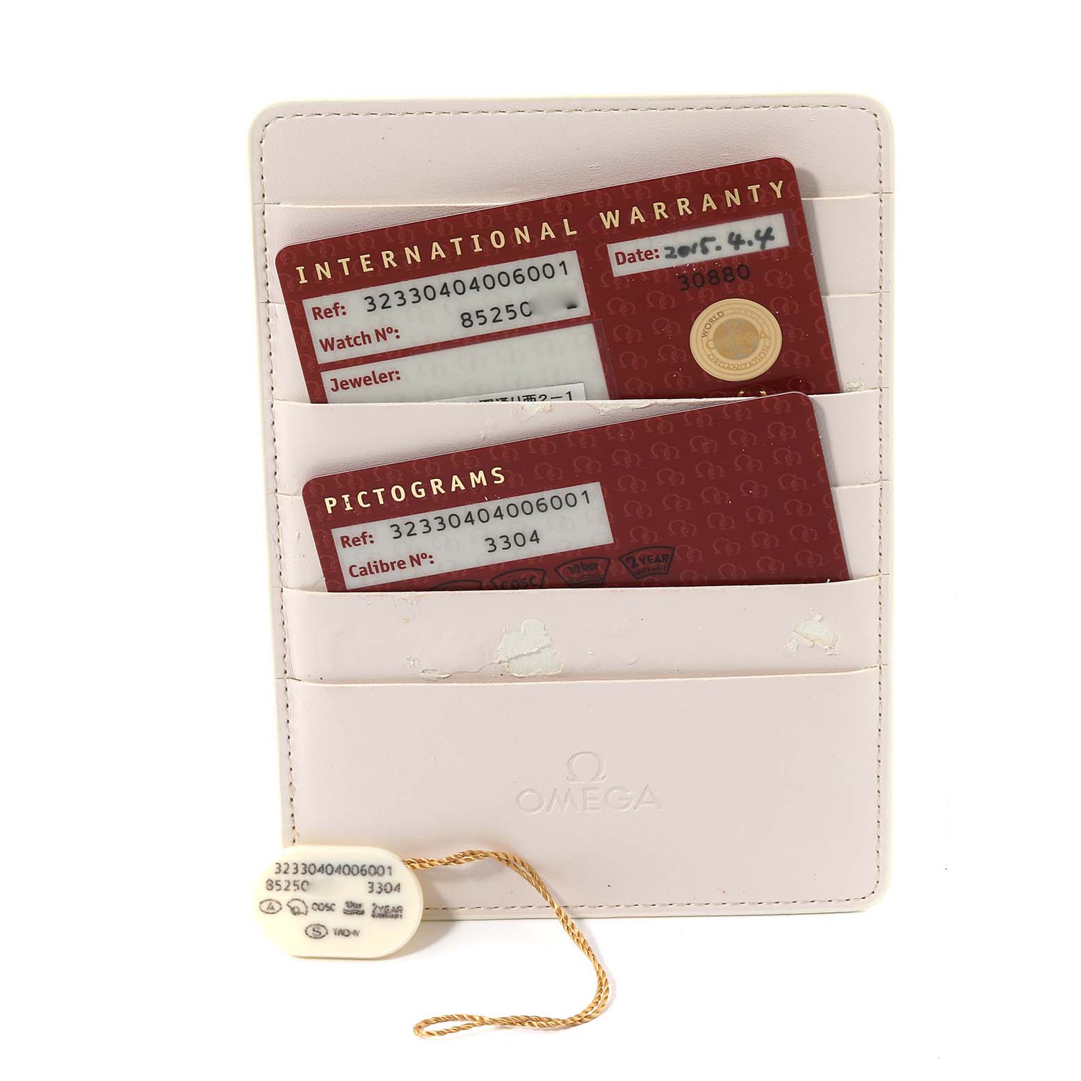 This image shows the warranty cards and tag for the Omega Speedmaster 323.30.40.40.06.001 Men's Stainless Steel Grey Dial 323.30.40.40.06.001 Men's Stainless Steel Grey Dial watch, displayed in a white cardholder.