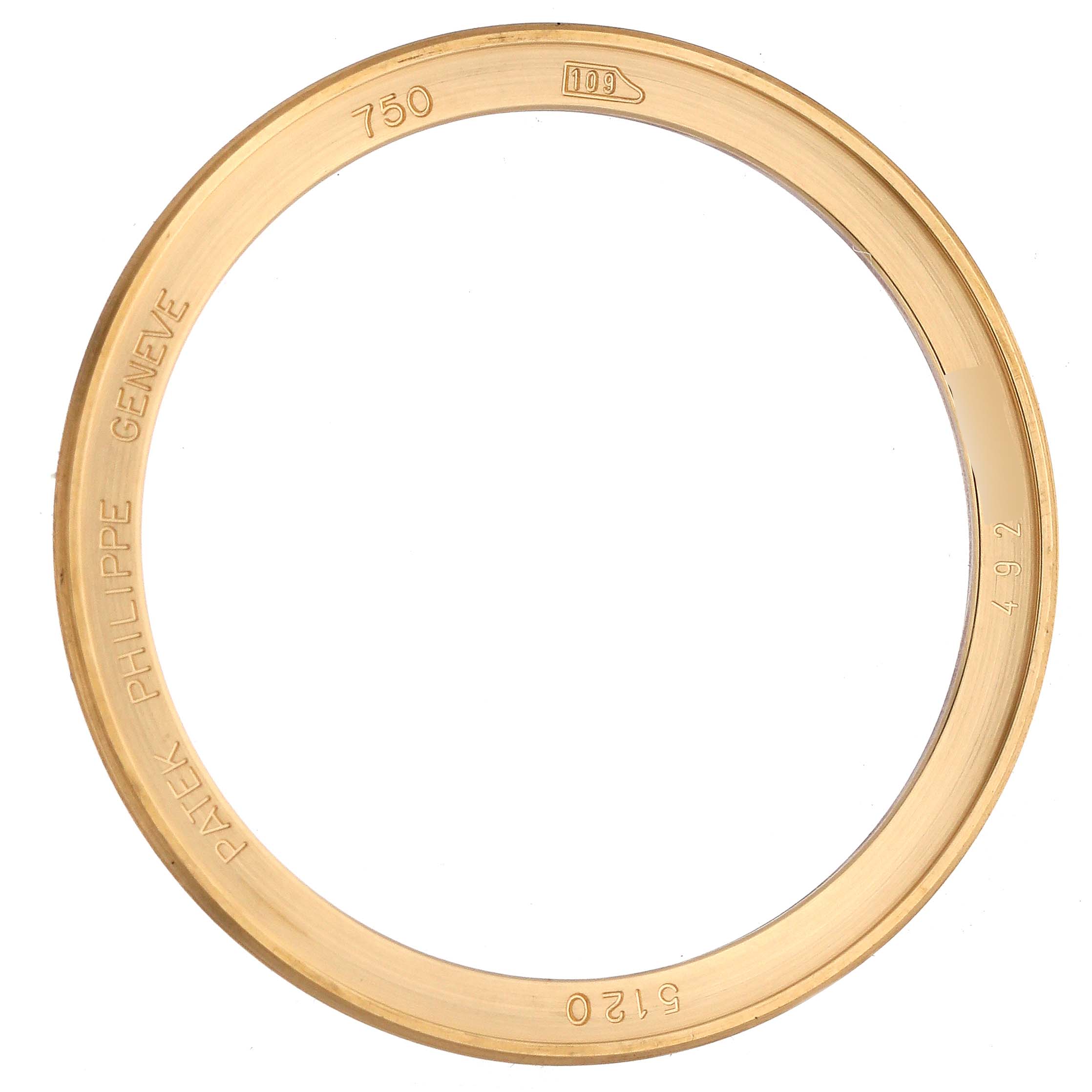 The image shows the gold bezel of a Patek Philippe Calatrava 5120J-001 Men's Yellow Gold White Dial 5120J-001 Men's Yellow Gold White Dial model watch, viewed from above.