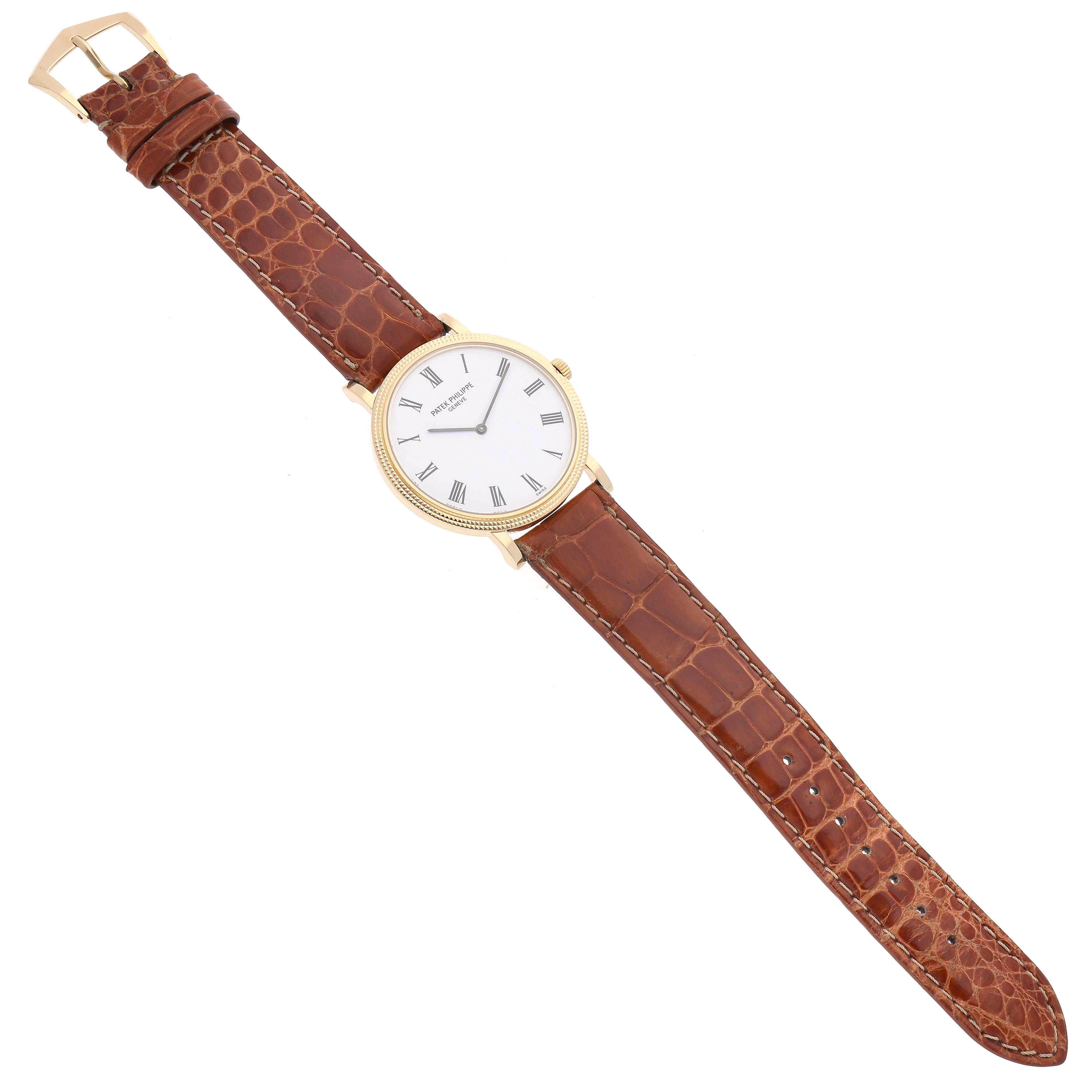 The image shows a Patek Philippe Calatrava 5120J-001 Men's Yellow Gold White Dial 5120J-001 Men's Yellow Gold White Dial watch with a brown leather strap, viewed from a top-down angle.