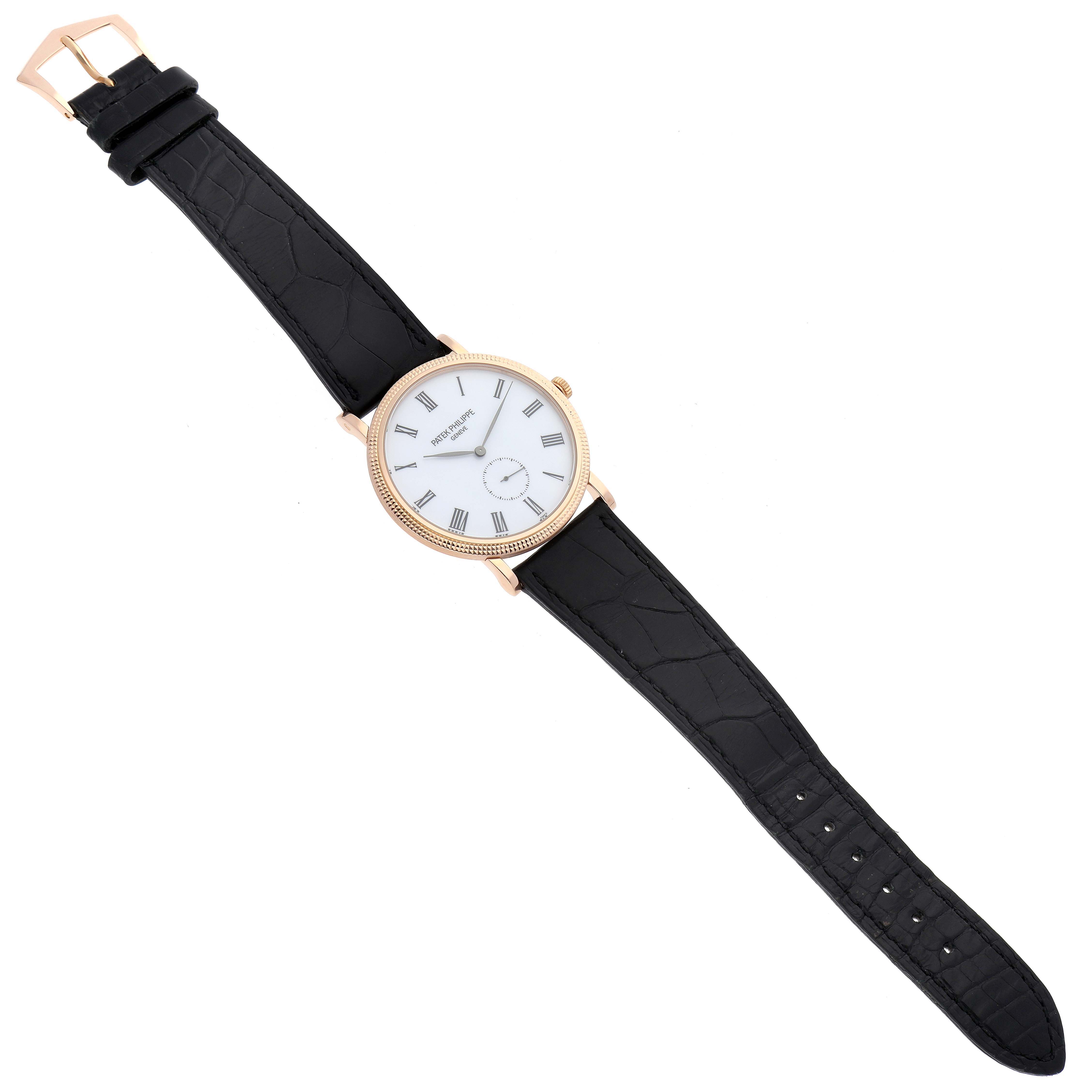 The image shows a top-down view of a Patek Philippe Calatrava 5119R-001 Men
s Rose Gold White Dial 5119R-001 Men
s Rose Gold White Dial watch with Roman numerals and a black leather strap.