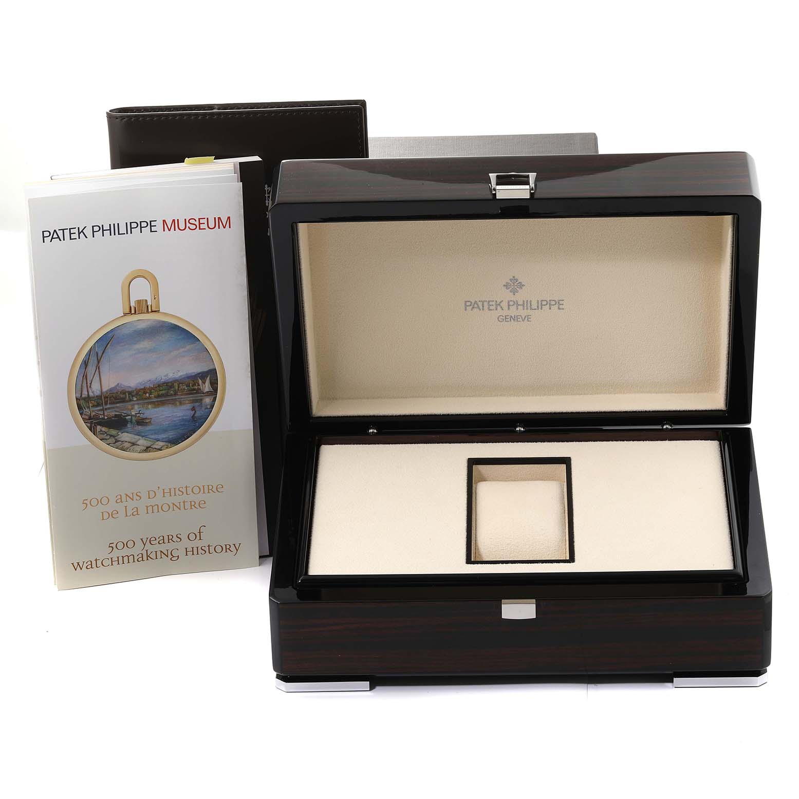 The image shows a Patek Philippe Complications 4947/1A-001 Men's Stainless Steel Blue Dial 4947/1A-001 Men's Stainless Steel Blue Dial model watch box, open to reveal its interior, with an accompanying brochure.