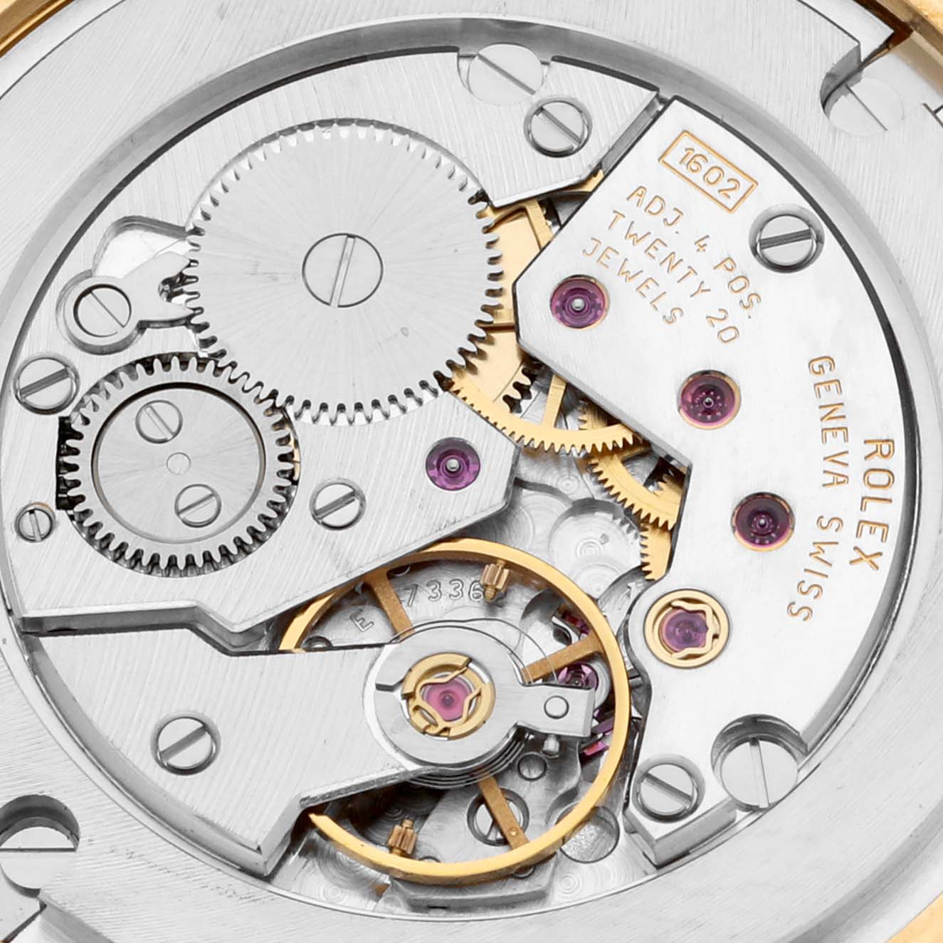 This close-up shows the intricate internal mechanism of a Rolex Cellini 5116/8 Men's Yellow Gold Silver Dial 5116/8 Men's Yellow Gold Silver Dial watch, including gears, screws, and jewel bearings.