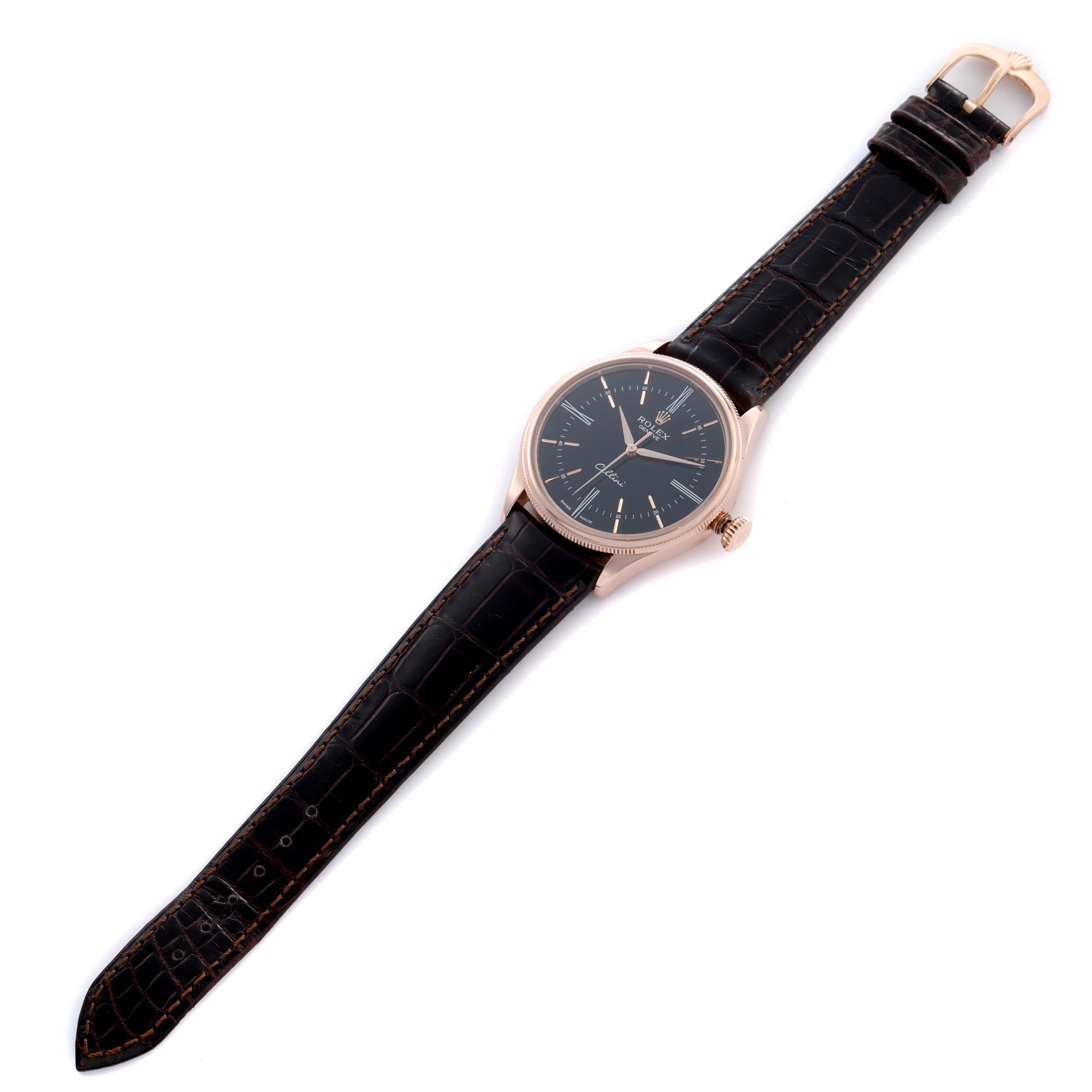 The Rolex Cellini 50505 Men's Rose Gold Black Dial watch is shown from a top-down angle, highlighting the black dial, rose gold case, and black leather strap.