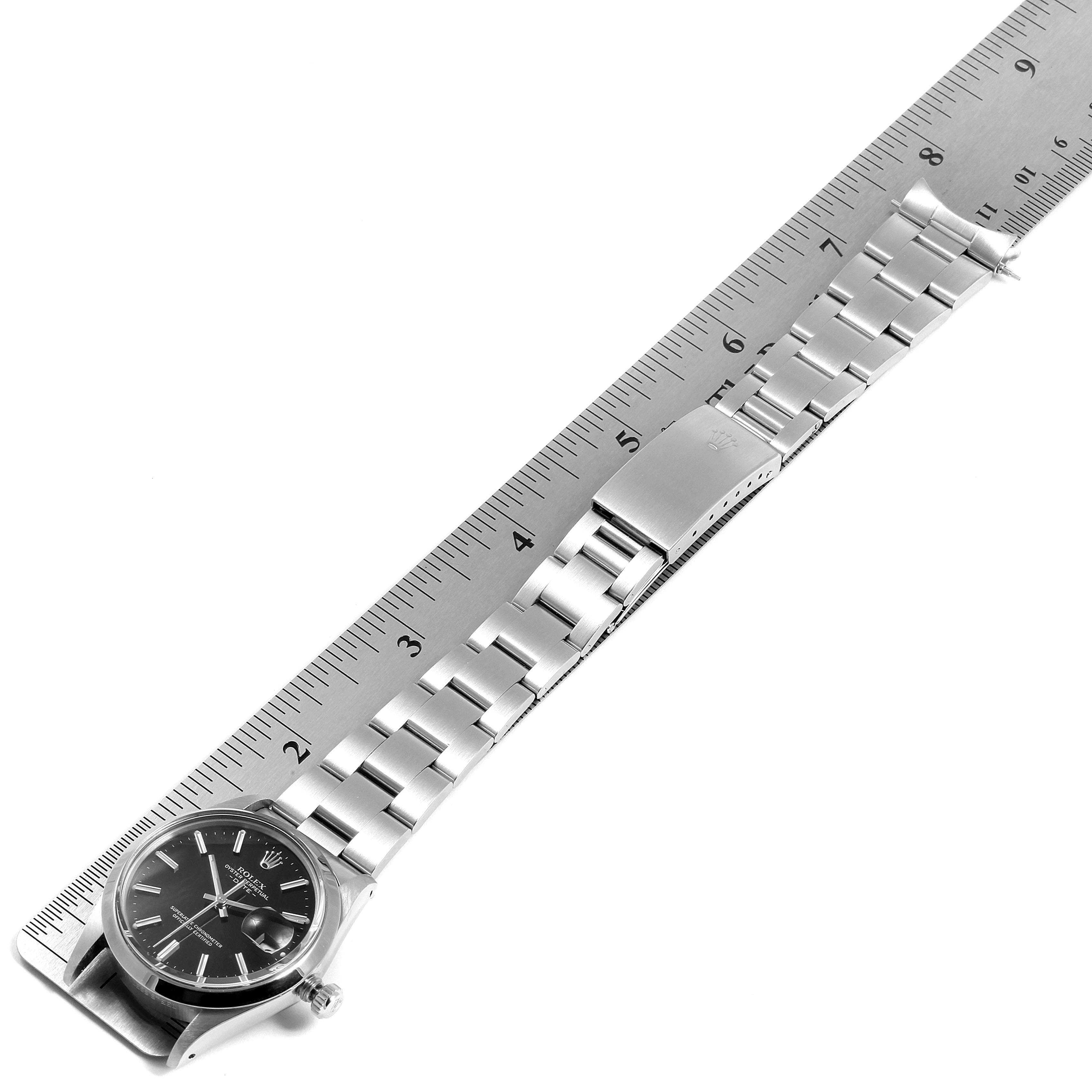 The image shows a Rolex Vintage Collection 15000 Men's Stainless Steel Black Dial 15000 Men's Stainless Steel Black Dial watch laid next to a ruler, highlighting the face, bracelet, and clasp.