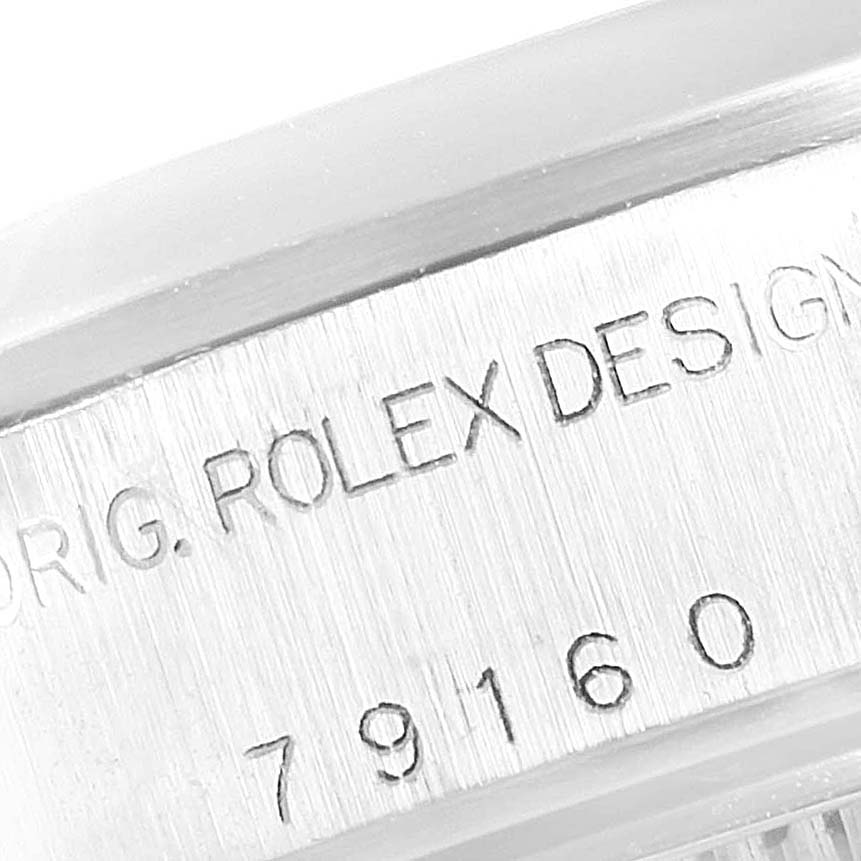 Close-up of the side of the case of a Rolex Datejust 79160 Women's Stainless Steel Silver Dial 79160 Women's Stainless Steel Silver Dial watch showing part of the bezel and engraved serial/model numbers.