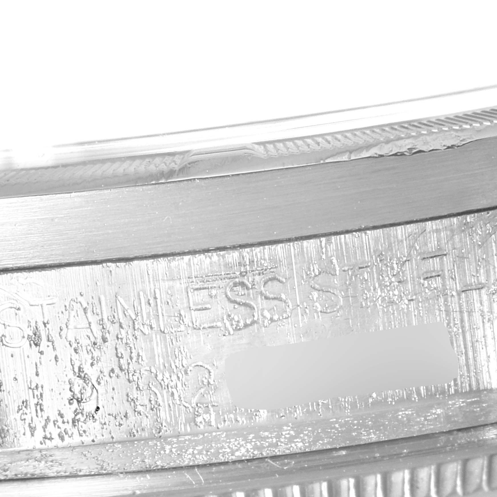 The image shows a close-up angle of the side of a Rolex Vintage Collection 15010 Men's Stainless Steel Silver Dial 15010 Men's Stainless Steel Silver Dial watch case with inscription details.