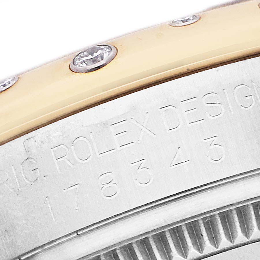 The image shows a close-up of the Rolex Datejust 178343 Men's Steel and Gold (two tone) Silver Dial's side, highlighting its engraved bezel and diamonds.