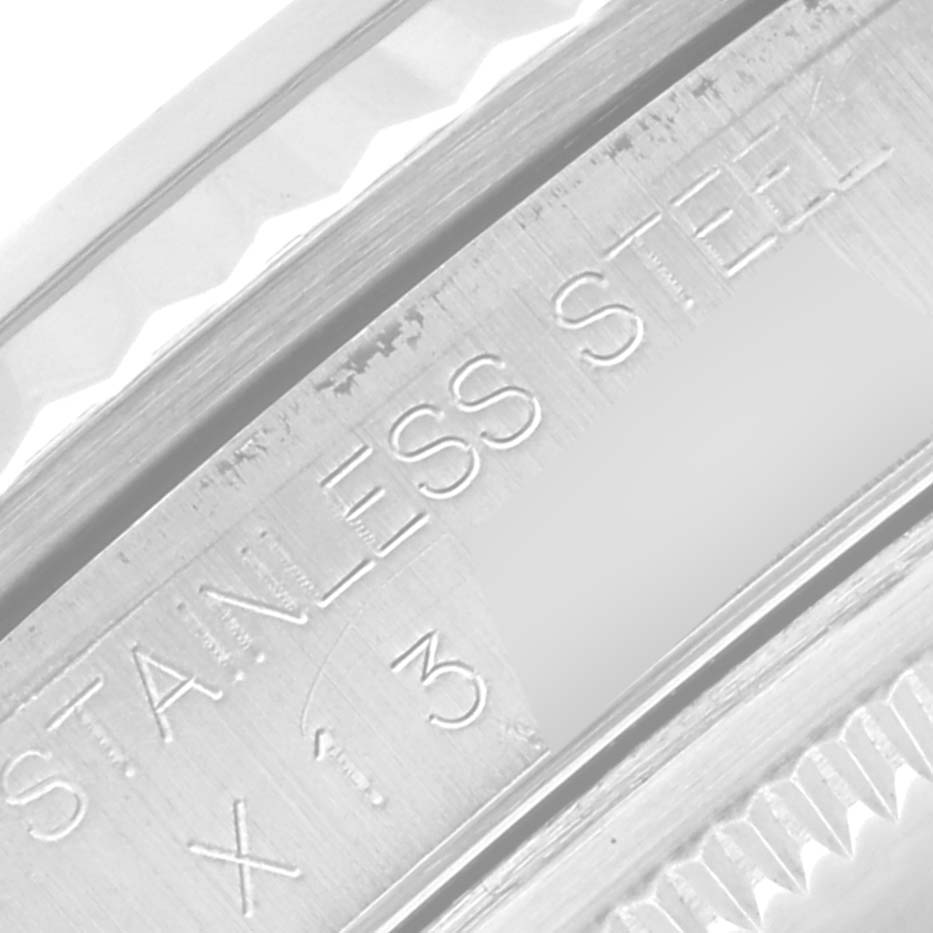 This close-up photo shows the "STAINLESS STEEL" engraving on the bezel of a Rolex Datejust 16234 Men's Stainless Steel Silver Dial 16234 Men's Stainless Steel Silver Dial watch.