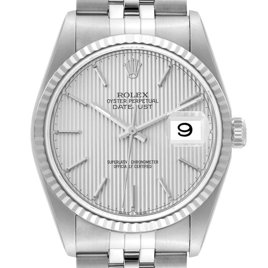 The image shows a front view of a Rolex Datejust watch, highlighting its silver dial, fluted bezel, and date window at 3 o'clock.