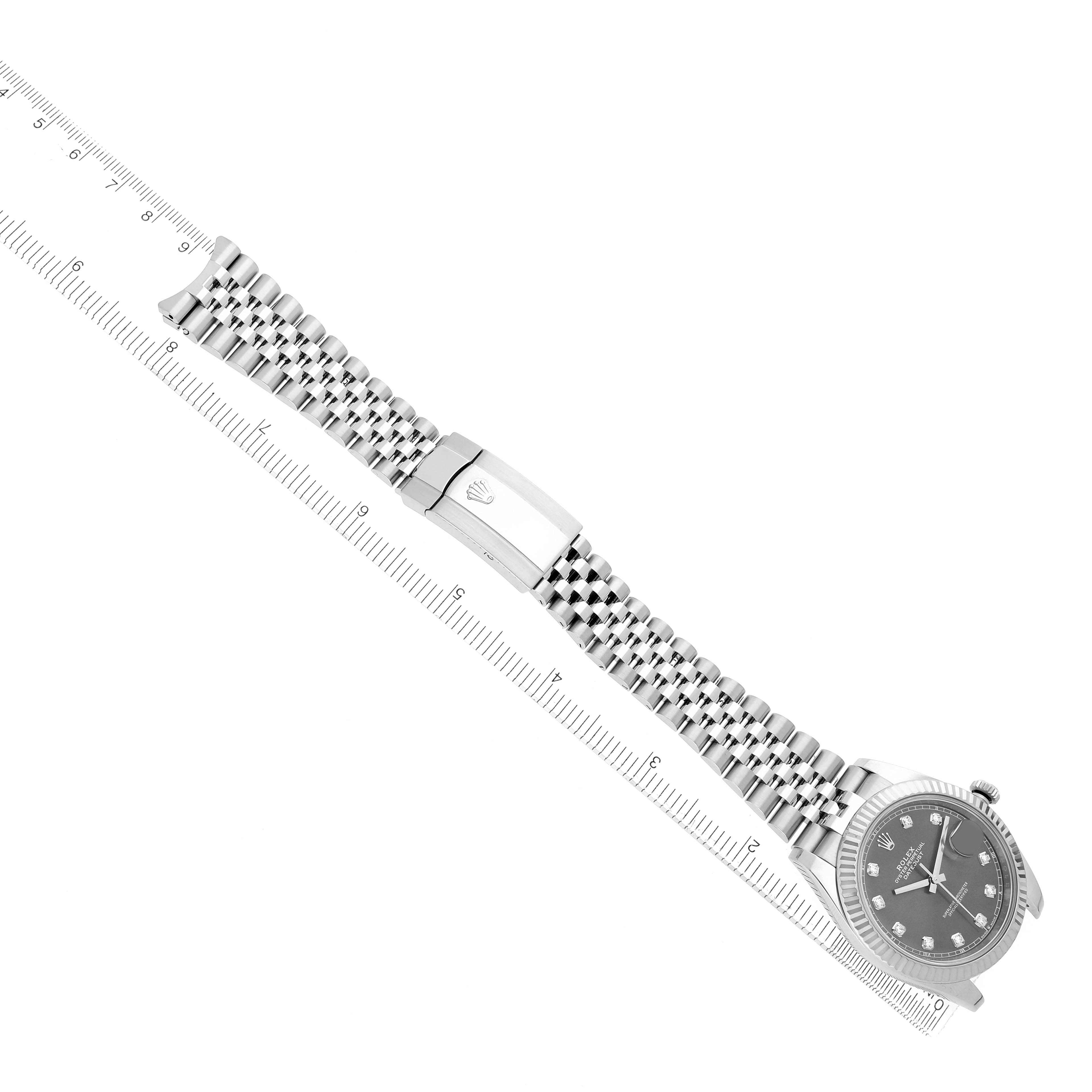 The Rolex Datejust 41 126334 Men
s Stainless Steel Grey Dial is shown diagonally with its full bracelet and clasp visible, next to a ruler for scale.