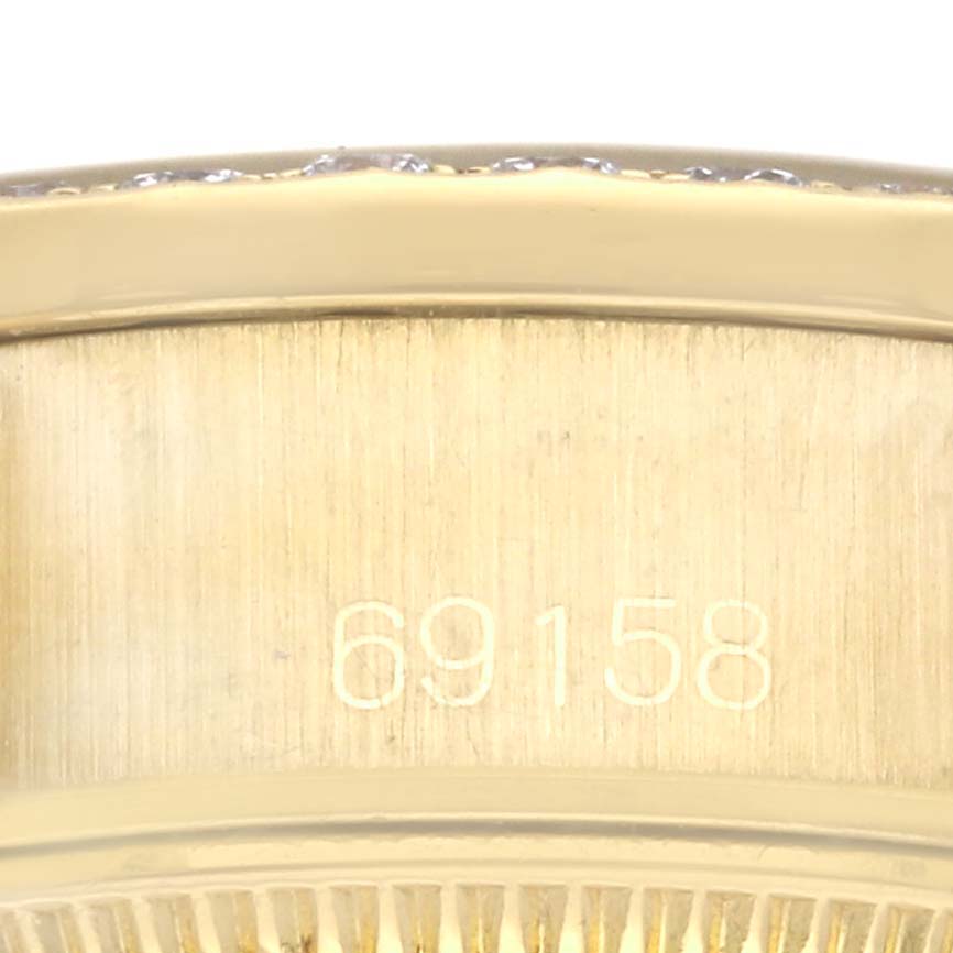 This close-up image shows the model number, "69158," engraved on the side of the case of a Rolex President 69158 Women's Yellow Gold Champagne Dial 69158 Women's Yellow Gold Champagne Dial watch.