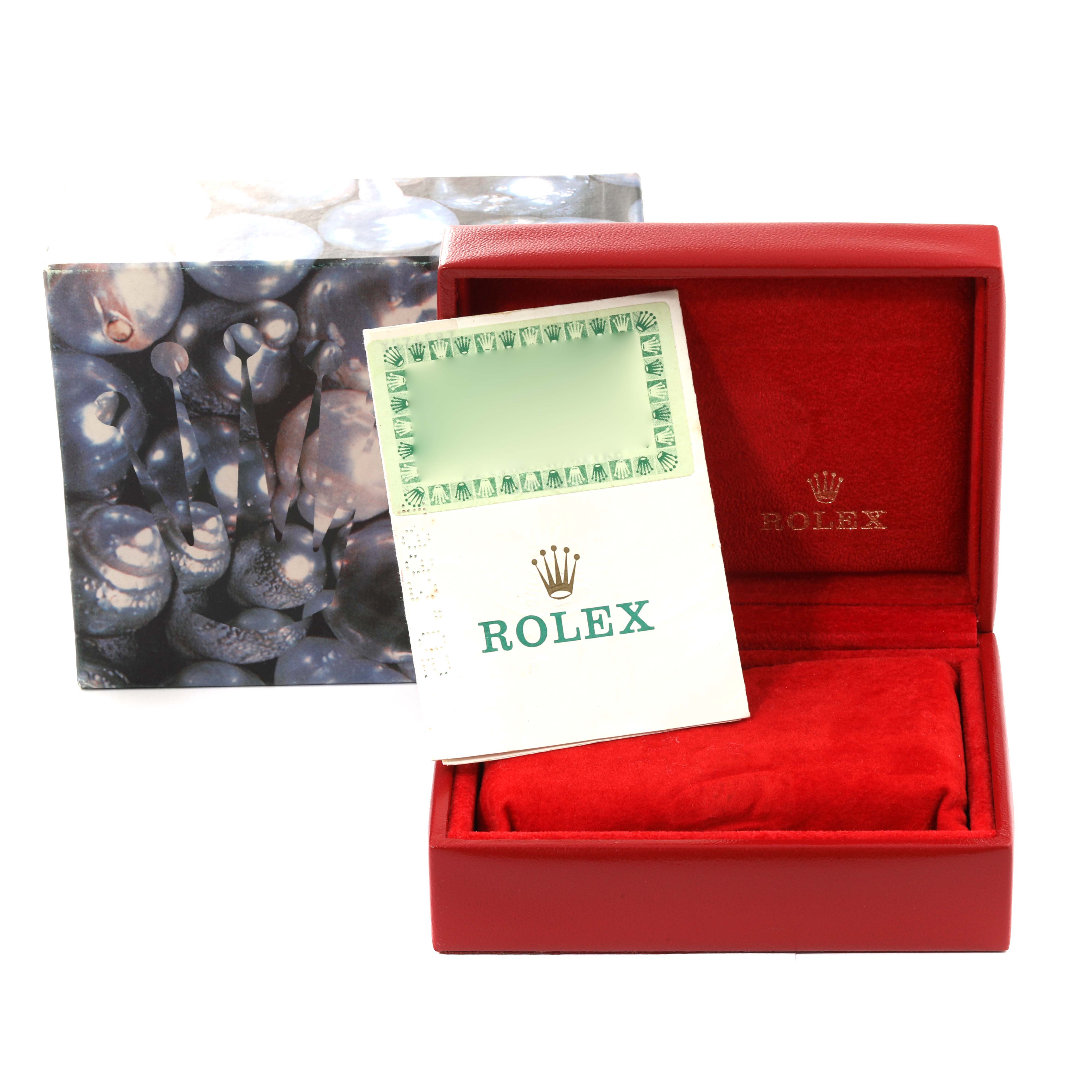 This image shows the packaging and documentation for a Rolex President 69158 Women's Yellow Gold Champagne Dial 69158 Women's Yellow Gold Champagne Dial model, including a red box and a warranty card.