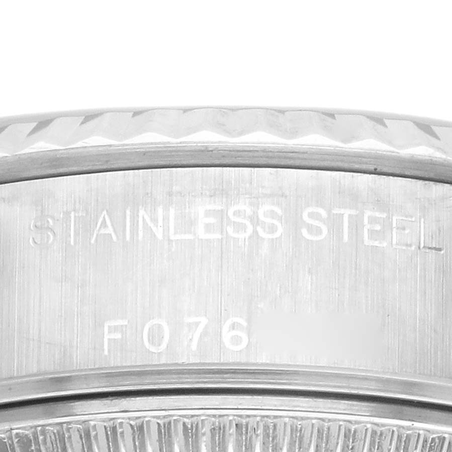 This image shows a close-up of the side of a Rolex Datejust 79174 Women's Stainless Steel Pink Dial 79174 Women's Stainless Steel Pink Dial watch, highlighting the "STAINLESS STEEL" engraving.