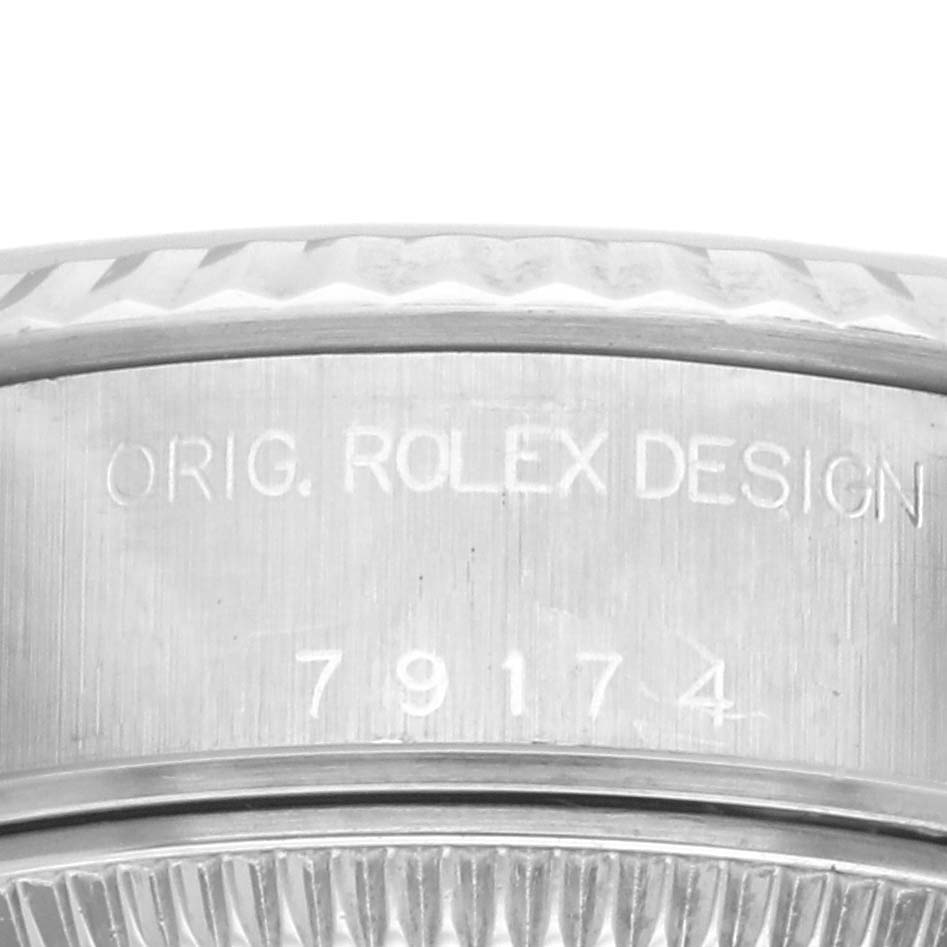 This image shows a close-up of the side engraving on the case of a Rolex Datejust 79174 Women's Stainless Steel Pink Dial 79174 Women's Stainless Steel Pink Dial model.