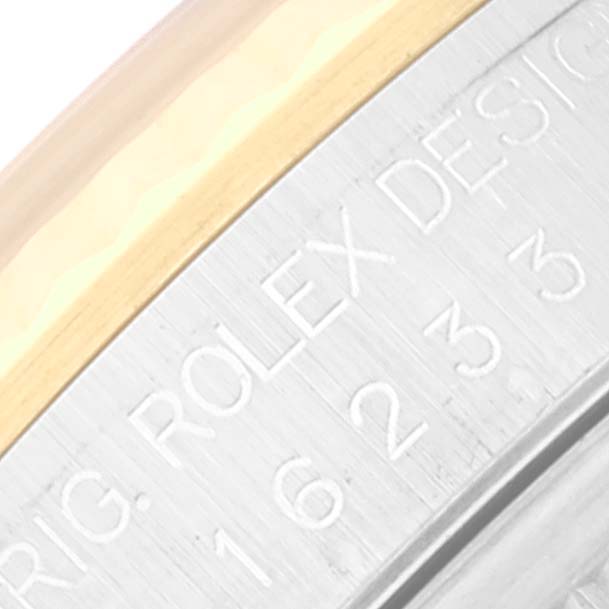 The image shows a close-up view of the side engraving on a Rolex Datejust 16233 Men's Steel and Gold (two tone) Champagne Dial 16233 Men's Steel and Gold (two tone) Champagne Dial watch case.