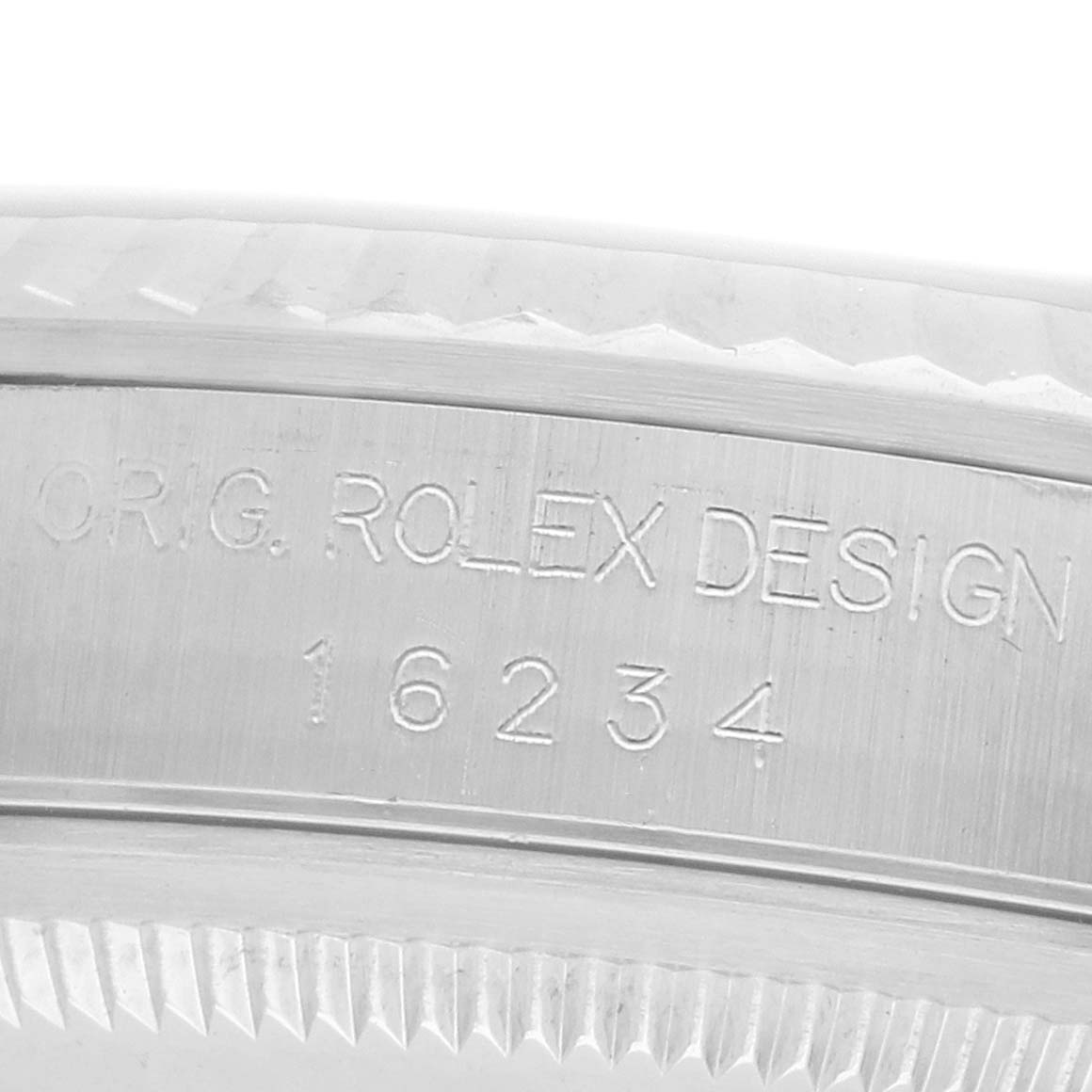 The image shows a close-up of the rim and engraved design number of a Rolex Datejust 16234 Men
s Stainless Steel Silver Dial watch.